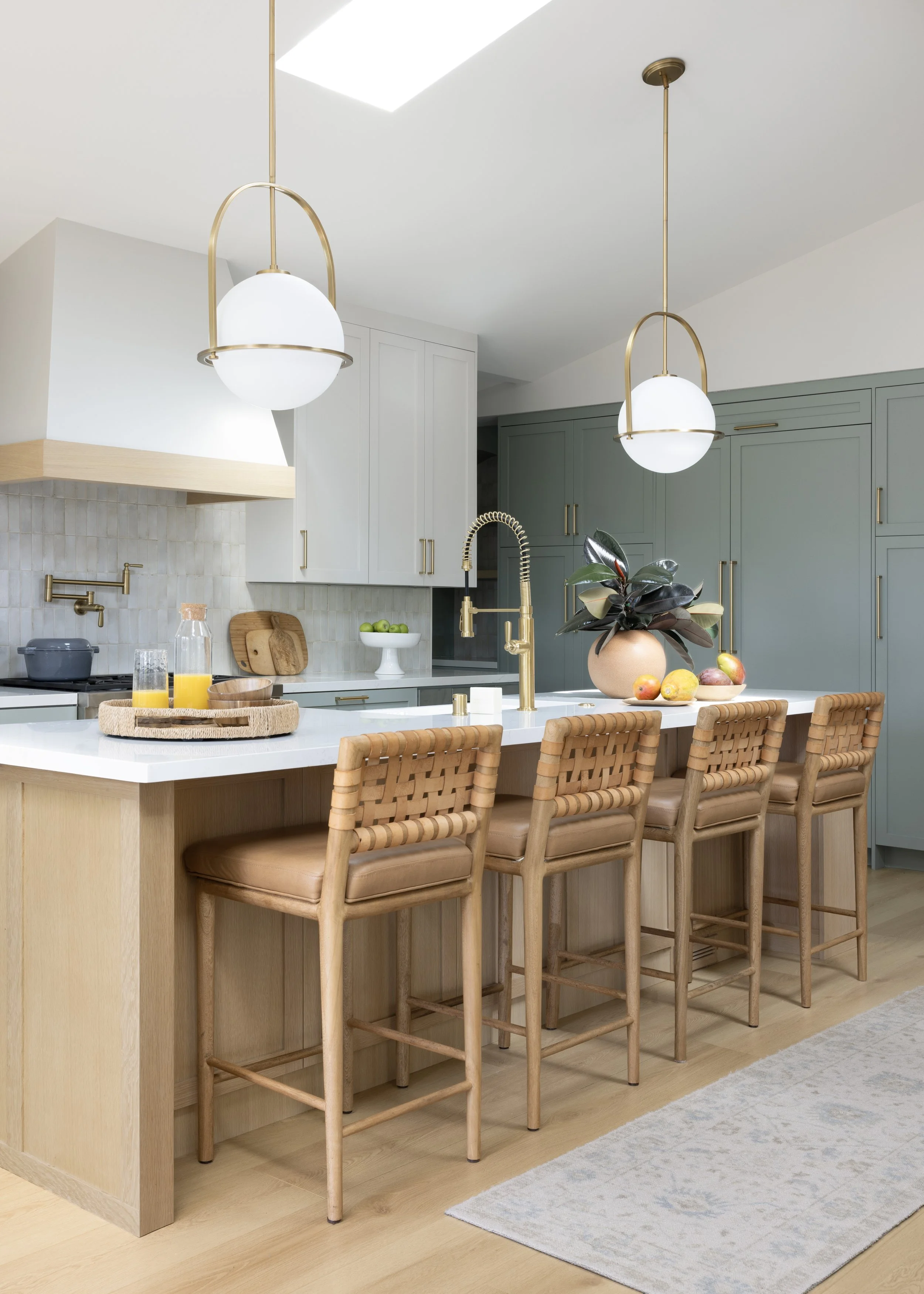 Kitchen renovation in Mill Valley designed by Marin interior designer Studio SQUIRE featuring Brass Pendants, Quartz Countertops, Marazzi Tile, and Custom Cabinetry