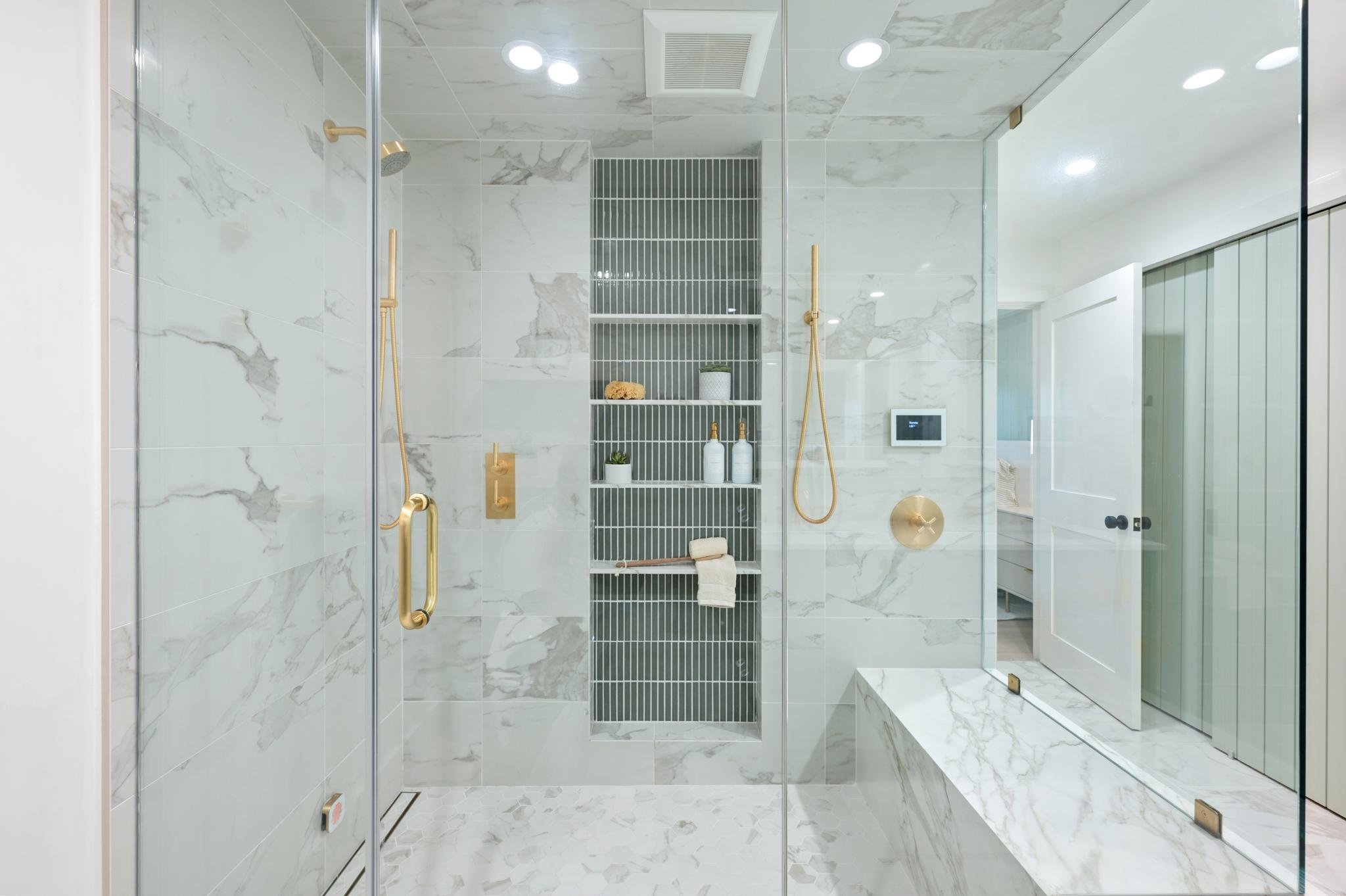 Primary Suite renovation in San Anselmo designed by Marin interior designer Studio SQUIRE featuring Marble Tile, Gold Fixtures, and Green Ceramic Tile.