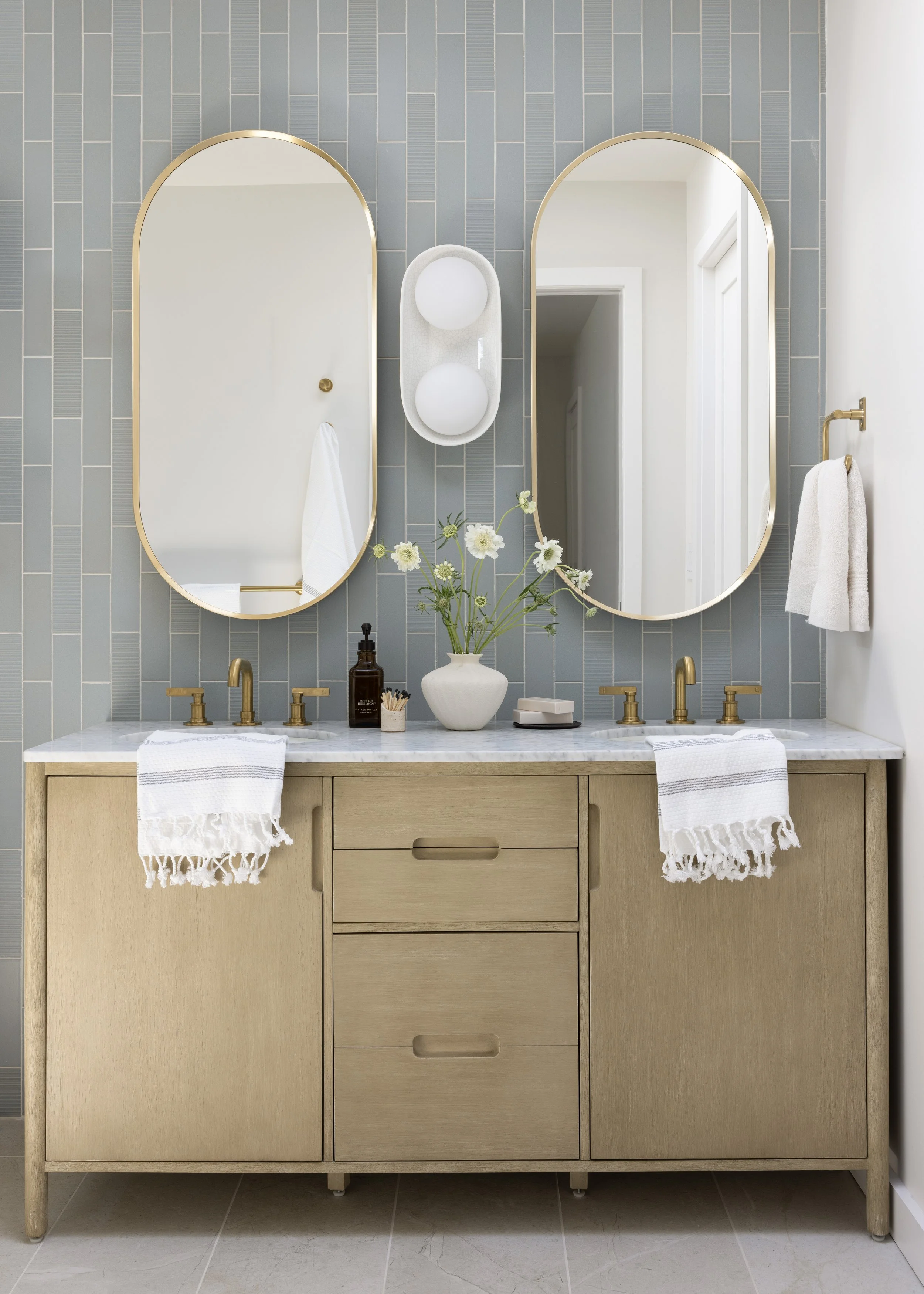 Master Bath renovation in Mill Valley designed by Marin interior designer Studio SQUIRE featuring Blue Tile, Wood Vanity, White Quartz, and Brass Fixtures