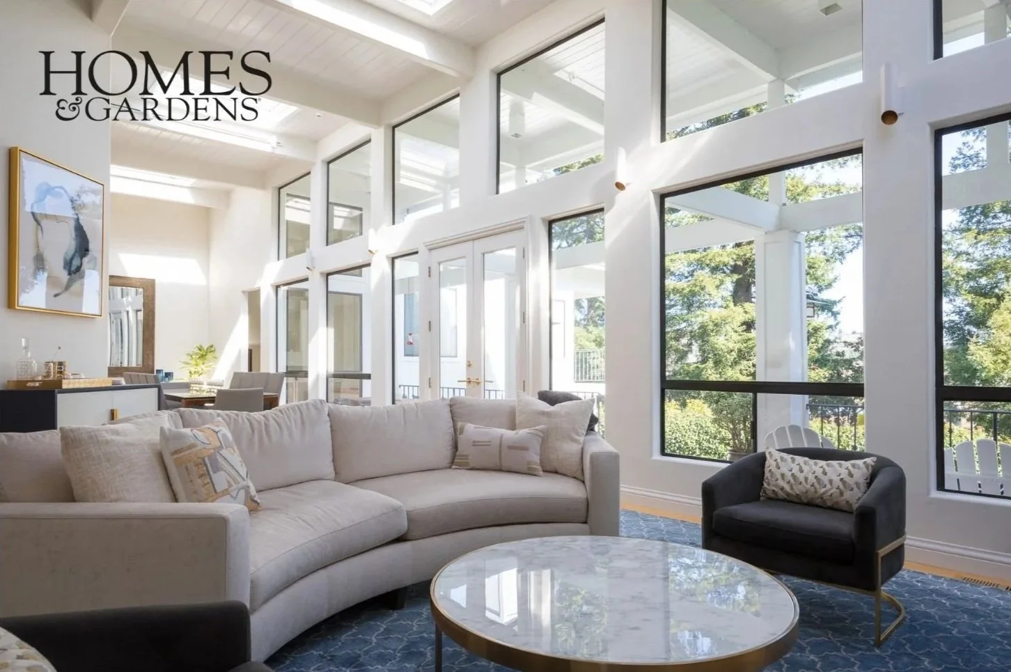 Living Room renovation in Mill Valley designed by Marin interior designer Studio SQUIRE featuring an upholstered sofa, accent chair, area rug, and marble coffee table