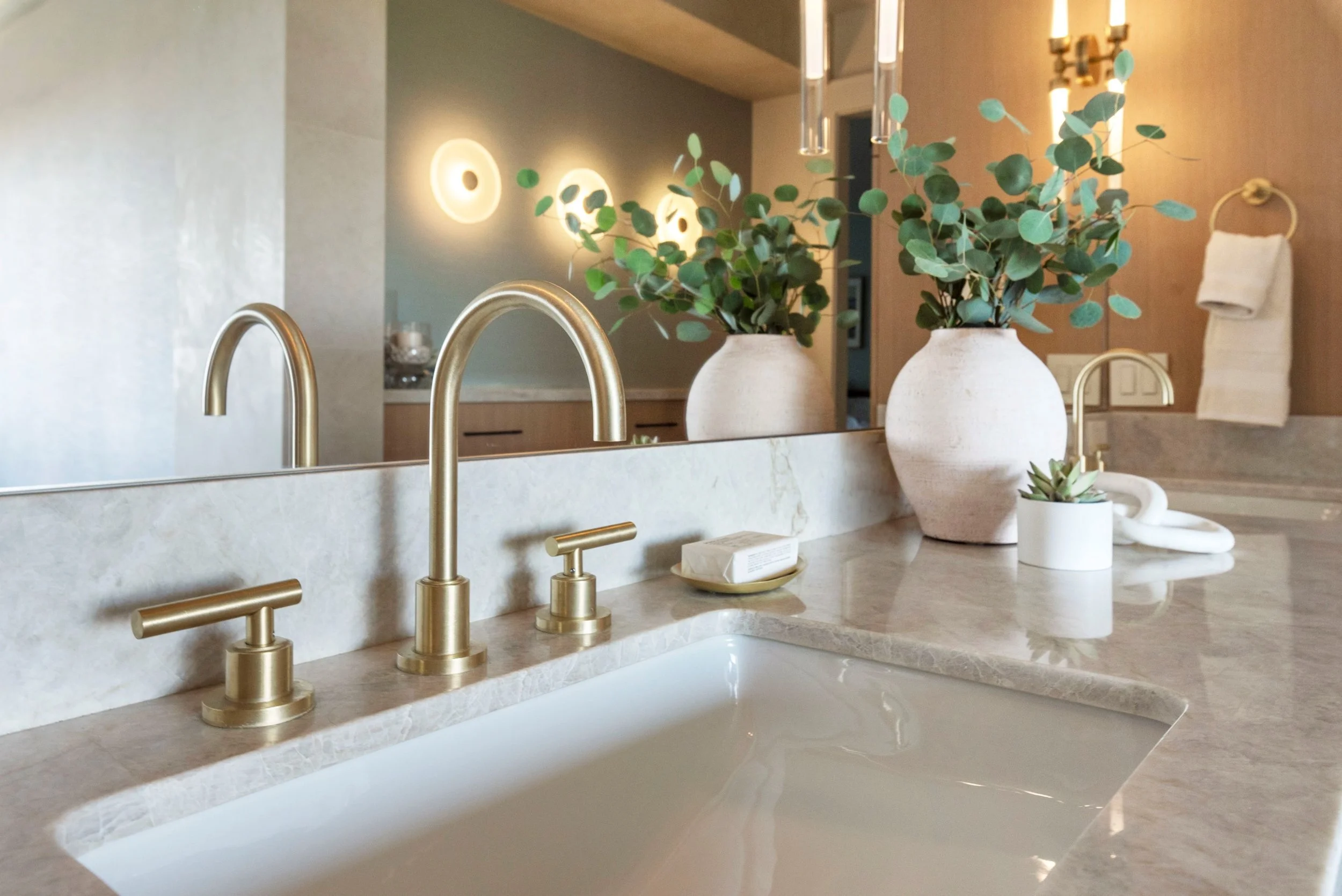 Luxury primary bathroom renovation in Tiburon designed by Marin interior designer Studio SQUIRE featuring white oak custom casework, quartzite countertops, satin brass plumbing fixtures, and oil rubbed bronze cabinet hardware.