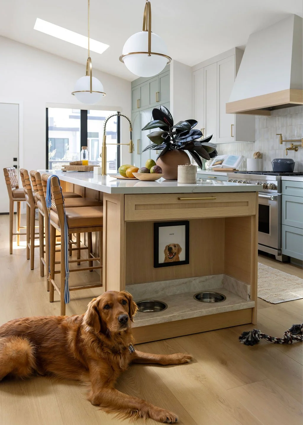 Kitchen renovation in Mill Valley designed by Marin interior designer Studio SQUIRE featuring Sage Green Cabinets and built-in dog bowls