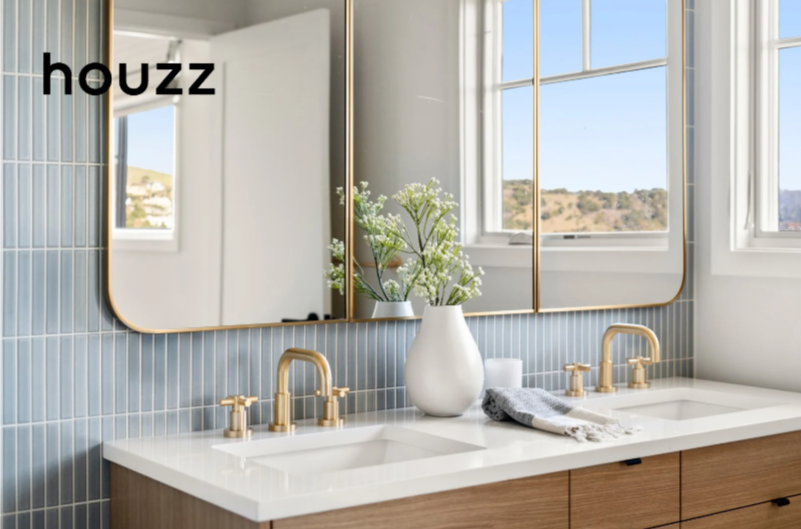Bathroom renovation in Tiburon designed by Marin interior designer Studio SQUIRE featuring light blue tile, wood vanity, and brass fixtures