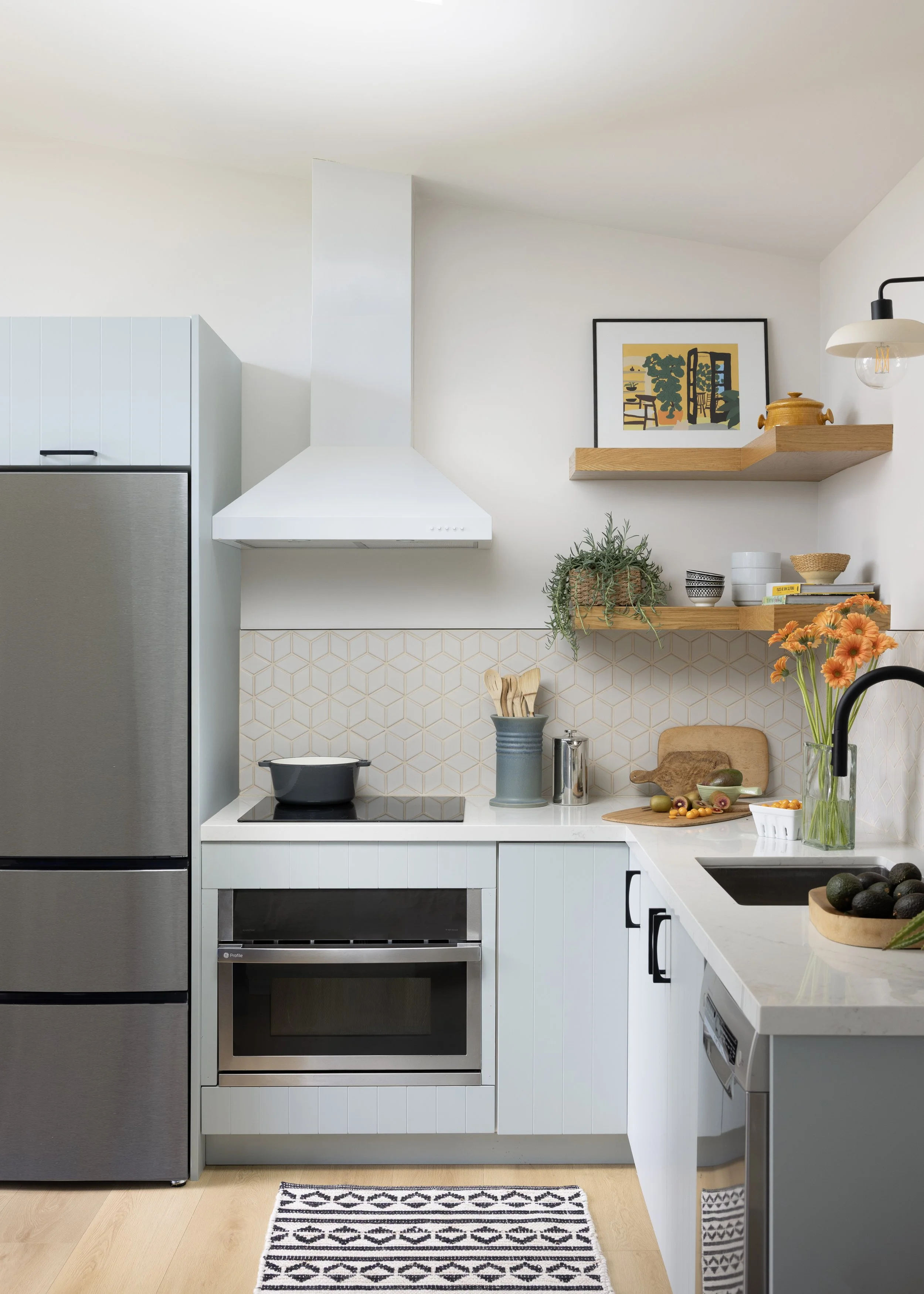 ADU renovation in Mill Valley designed by Marin interior designer Studio SQUIRE featuring Light Blue Cabinetry, Open Shelving, and Black Hardware