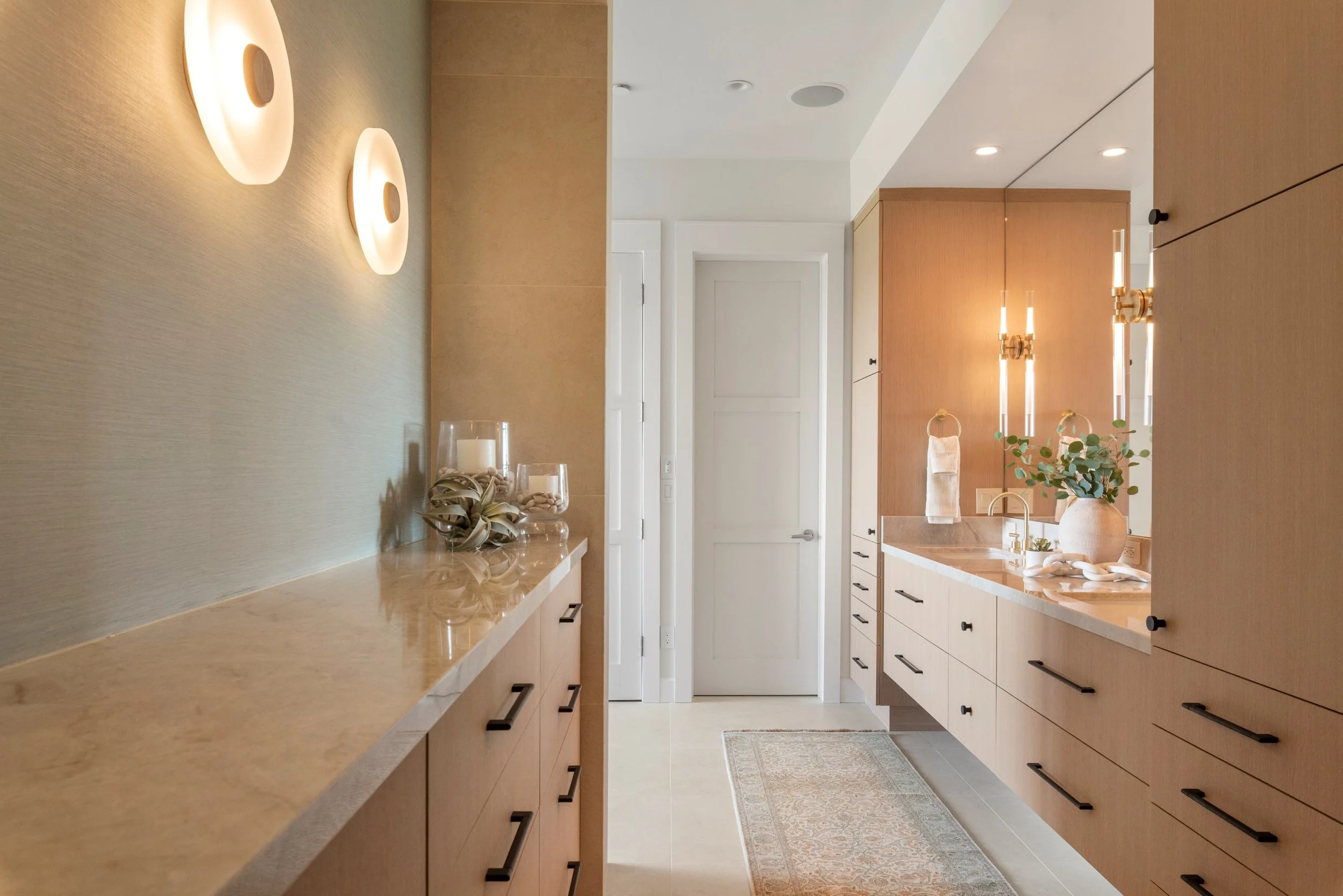 Luxury primary bathroom renovation in Tiburon designed by Marin interior designer Studio SQUIRE featuring white oak custom casework, quartzite countertops, satin brass plumbing fixtures, and oil rubbed bronze cabinet hardware.