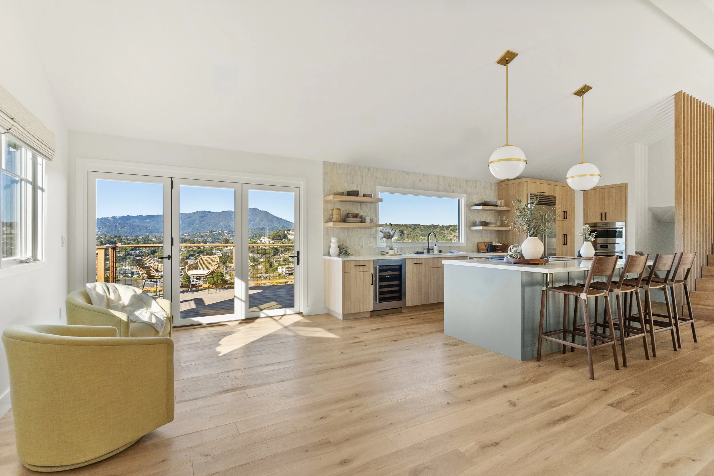 Kitchen renovation in Tiburon designed by Marin interior designer Studio SQUIRE featuring white oak custom cabinets, open shelving, a sage green island, and views.