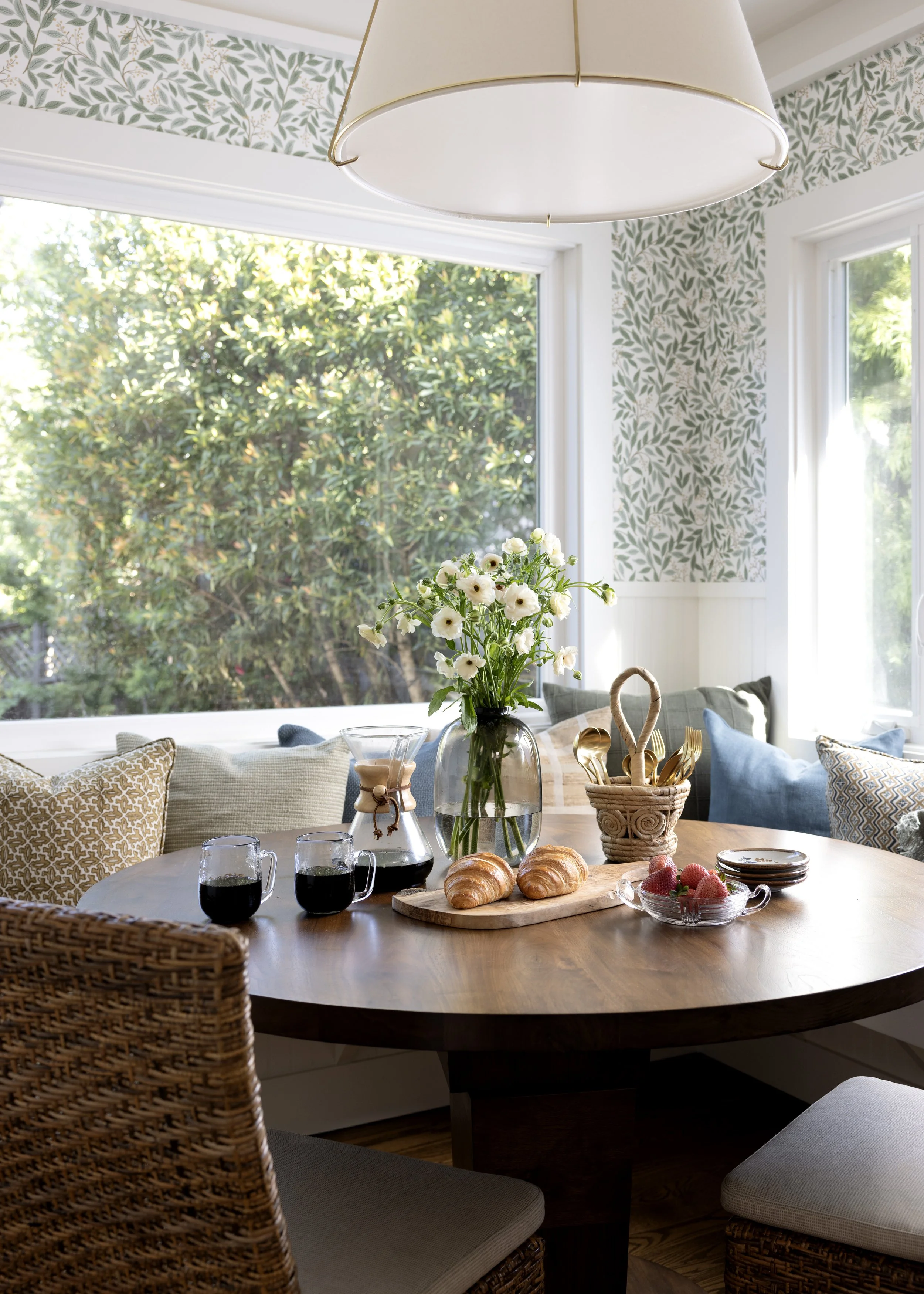 Kitchen renovation in Kentfield designed by Marin interior designer Studio SQUIRE featuring Walnut Wood Table, Wainscoting, Pillows, Brass Light Fixture, and Floral Wallpaper