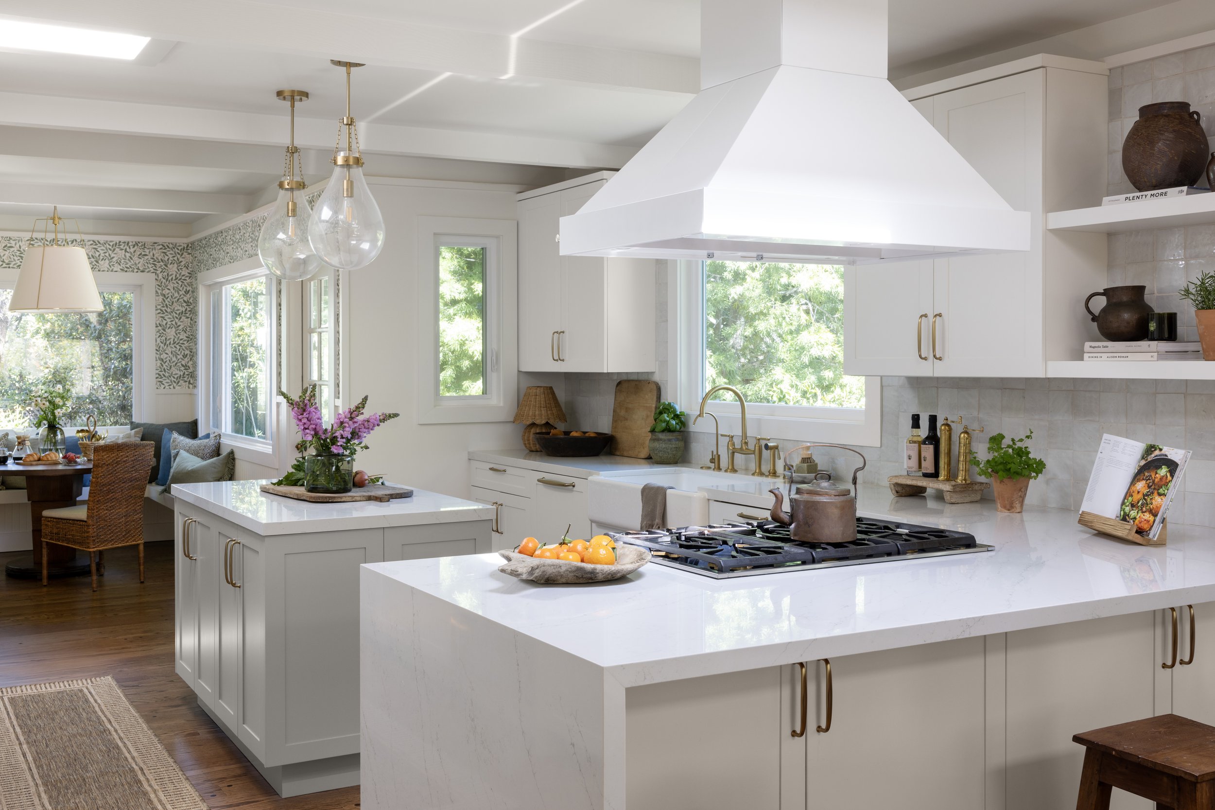Kitchen renovation in Kentfield designed by Marin interior designer Studio SQUIRE featuring hana sky quartz, brass fixtures, open shelving, and handmade tile