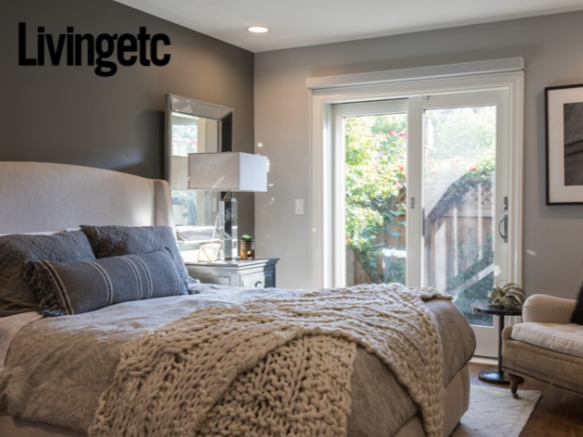 Bedroom renovation in Mill Valley designed by Marin interior designer Studio SQUIRE featuring an upholstered headboard, accent chair, throw pillows, chunky knit blanket, and table lamp