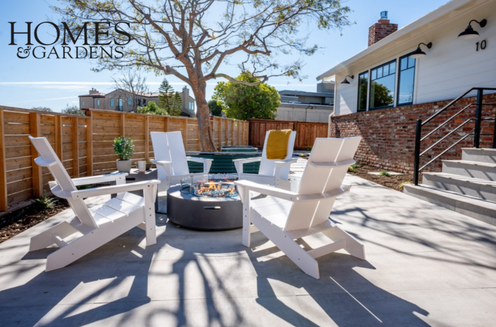 Home renovation in Tiburon designed by Marin interior designer Studio SQUIRE featuring goose neck lighting fixtures, fire pit, and lounge chairs