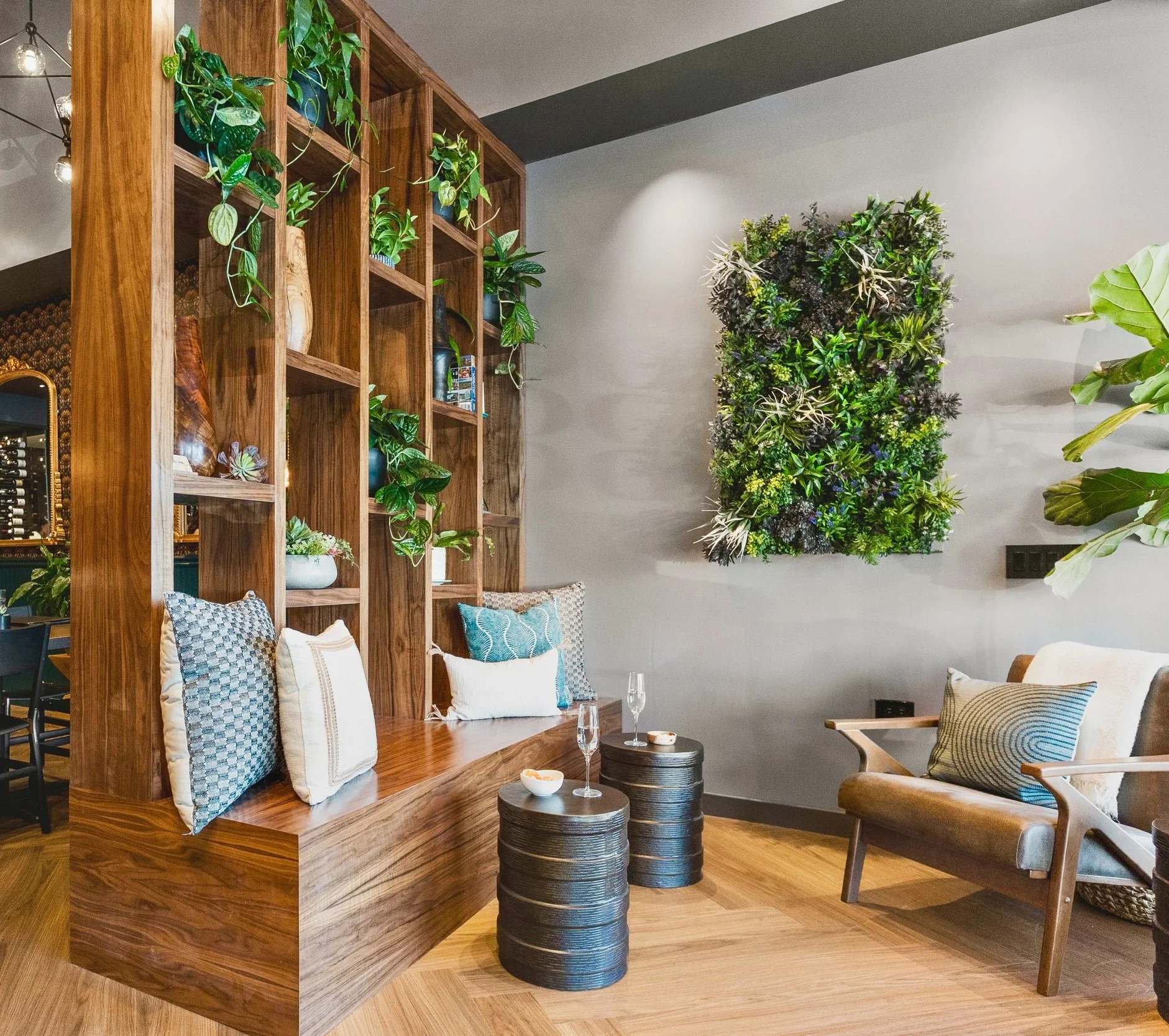 Commercial wine bar renovation in Belvedere-Tiburon designed by Marin interior designer Studio SQUIRE featuring a Plant Wall, Side Chair, Wood Shelving, and Accent Pillows