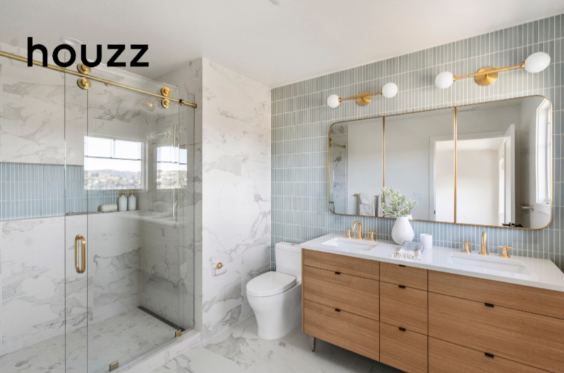 Bathroom renovation in Tiburon designed by Marin interior designer Studio SQUIRE featuring light blue tile, marble tile, wood vanity, and brass features