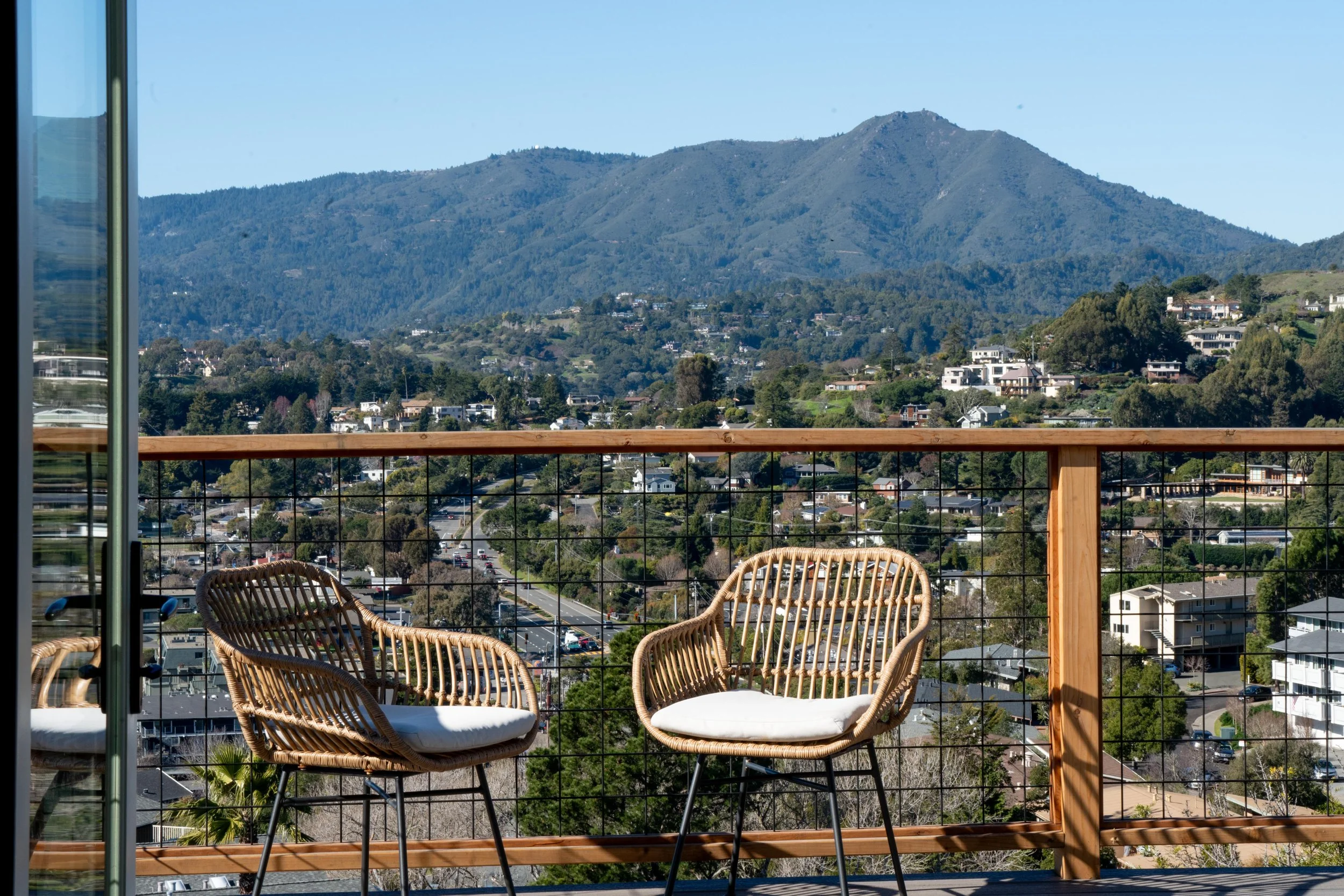 Outdoor living space designed by Marin interior designer Studio SQUIRE for a Tiburon home featuring deck with view of Mount Tamalpais.