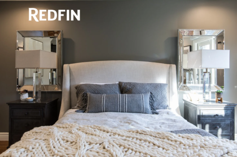 Bedroom renovation in Mill Valley designed by Marin interior designer Studio SQUIRE featuring an upholstered bed, nickel mirrors, accent pillows, throw blanket, table lamps, and nightstands