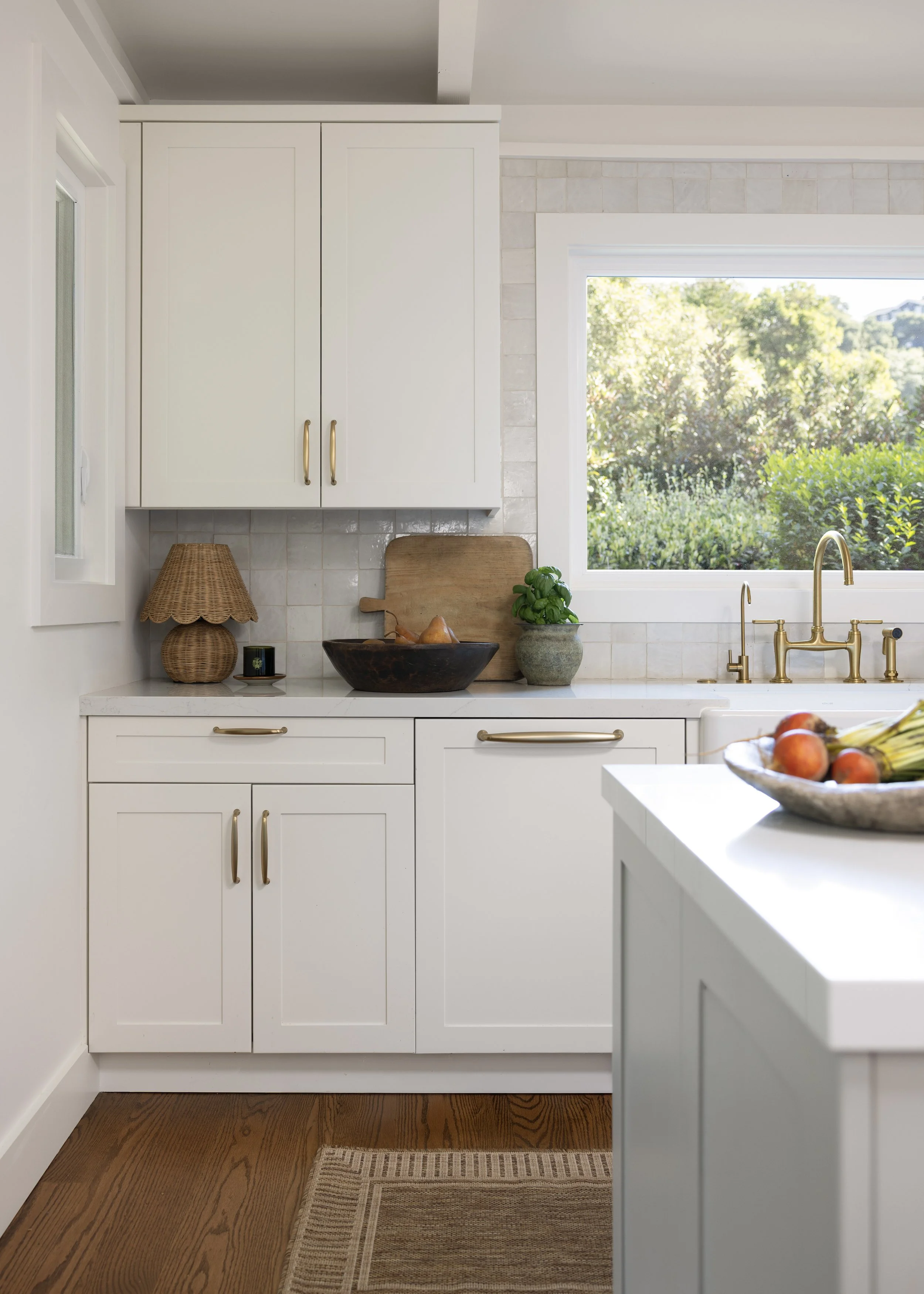 Kitchen renovation in Kentfield designed by Marin interior designer Studio SQUIRE featuring Custom Cabinetry, Brass Handles, Brass Fixtures, and Quartz Countertop