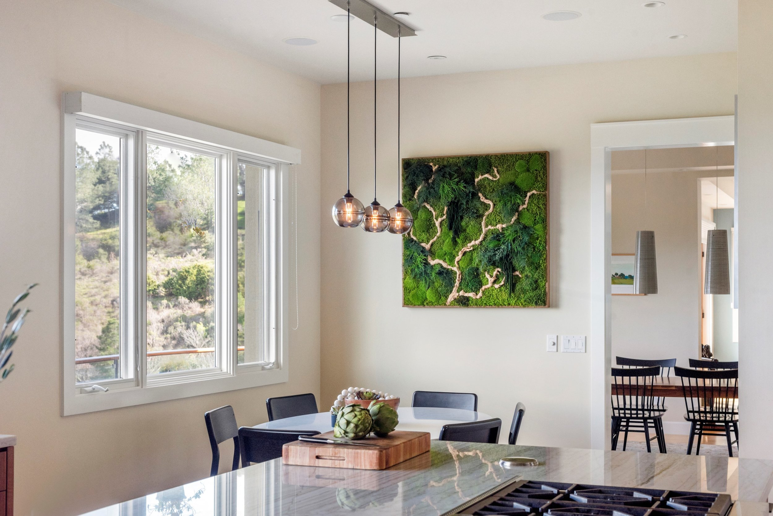 Kitchen renovation in Tiburon designed by Marin interior designer Studio SQUIRE featuring a modern breakfast nook with a custom preserved moss plant painting.