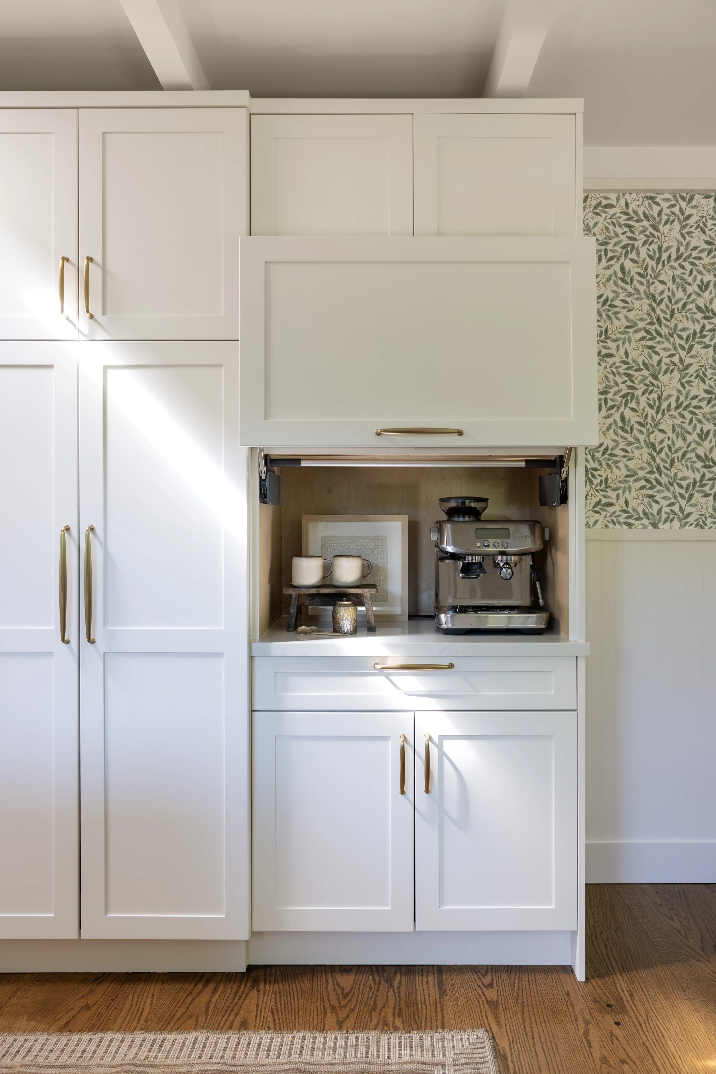 Kitchen renovation in Kentfield designed by Marin interior designer Studio SQUIRE featuring Appliance Garage, Custom Cabinetry, Quartz Countertop, Brass Hardware, and Floral Wallpaper
