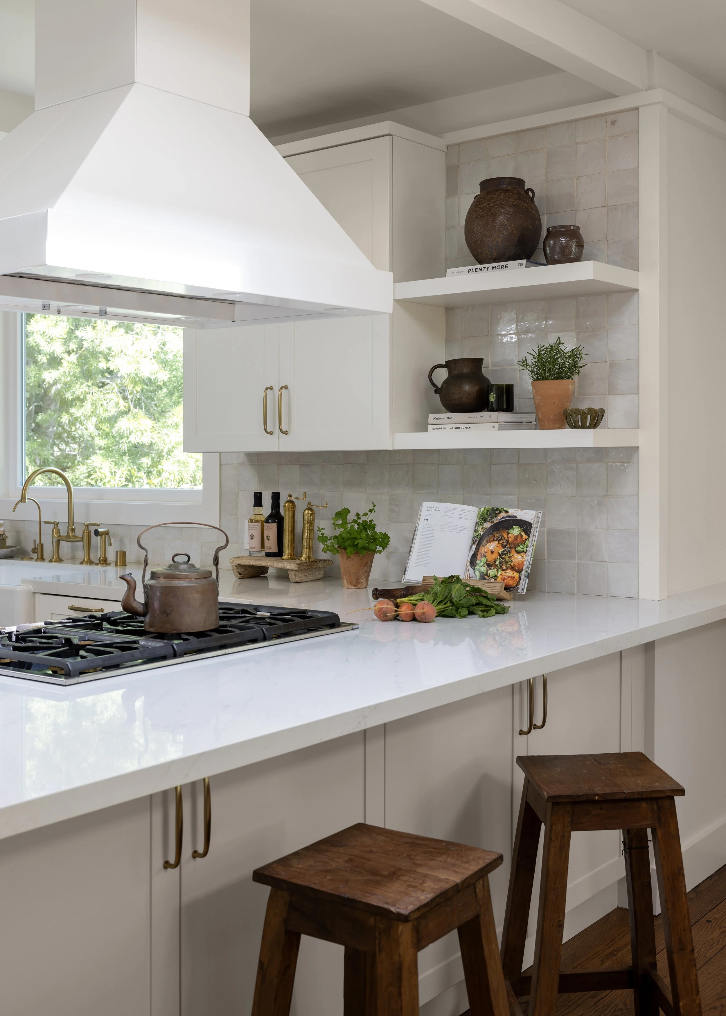 Kitchen renovation in Kentfield designed by Marin interior designer Studio SQUIRE featuring Custom Cabinetry, Brass Handles, Brass Fixtures, Shelving, Wood Counter Stools, and Quartz Countertop