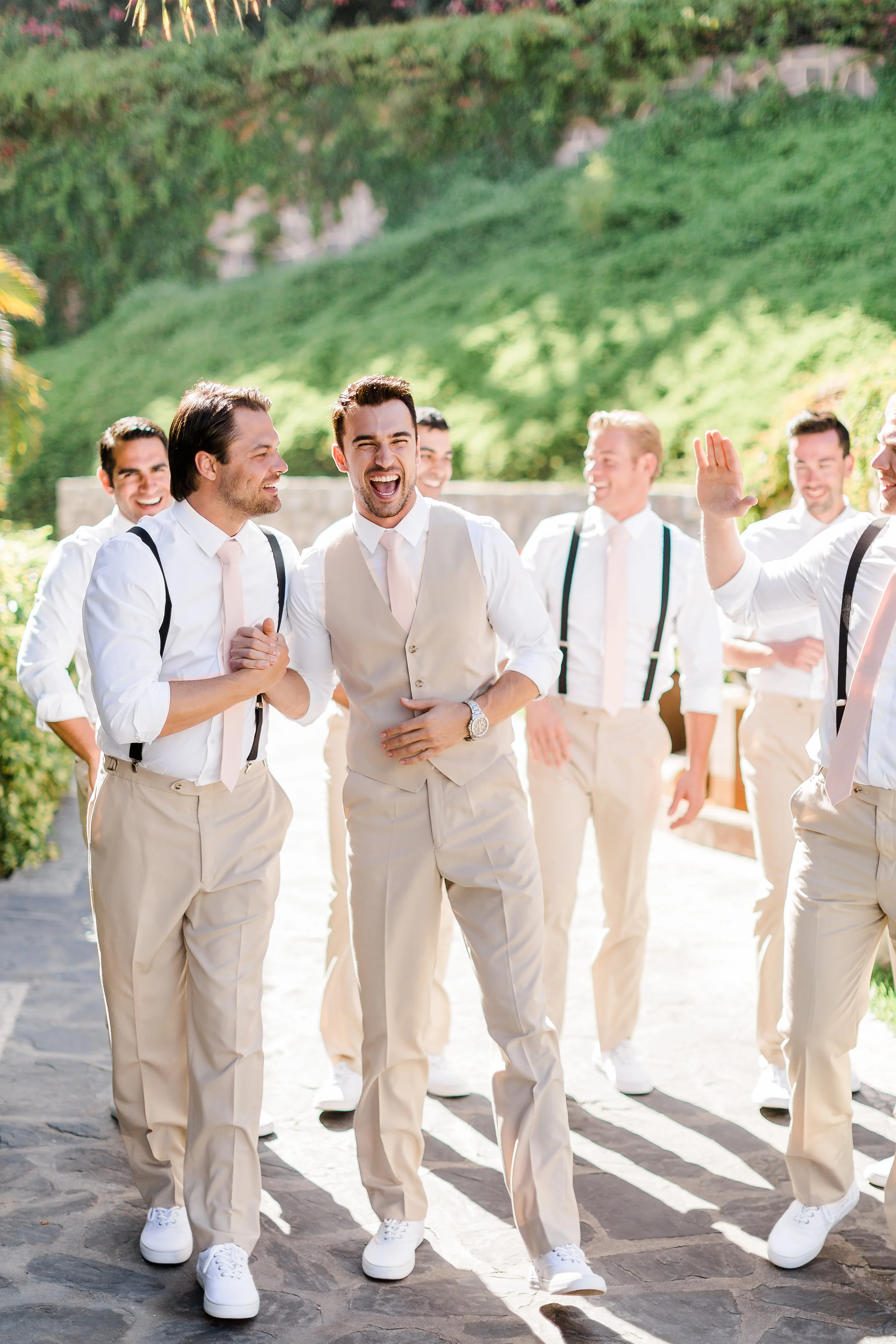 Groom John Grohl walks with his groomsmen