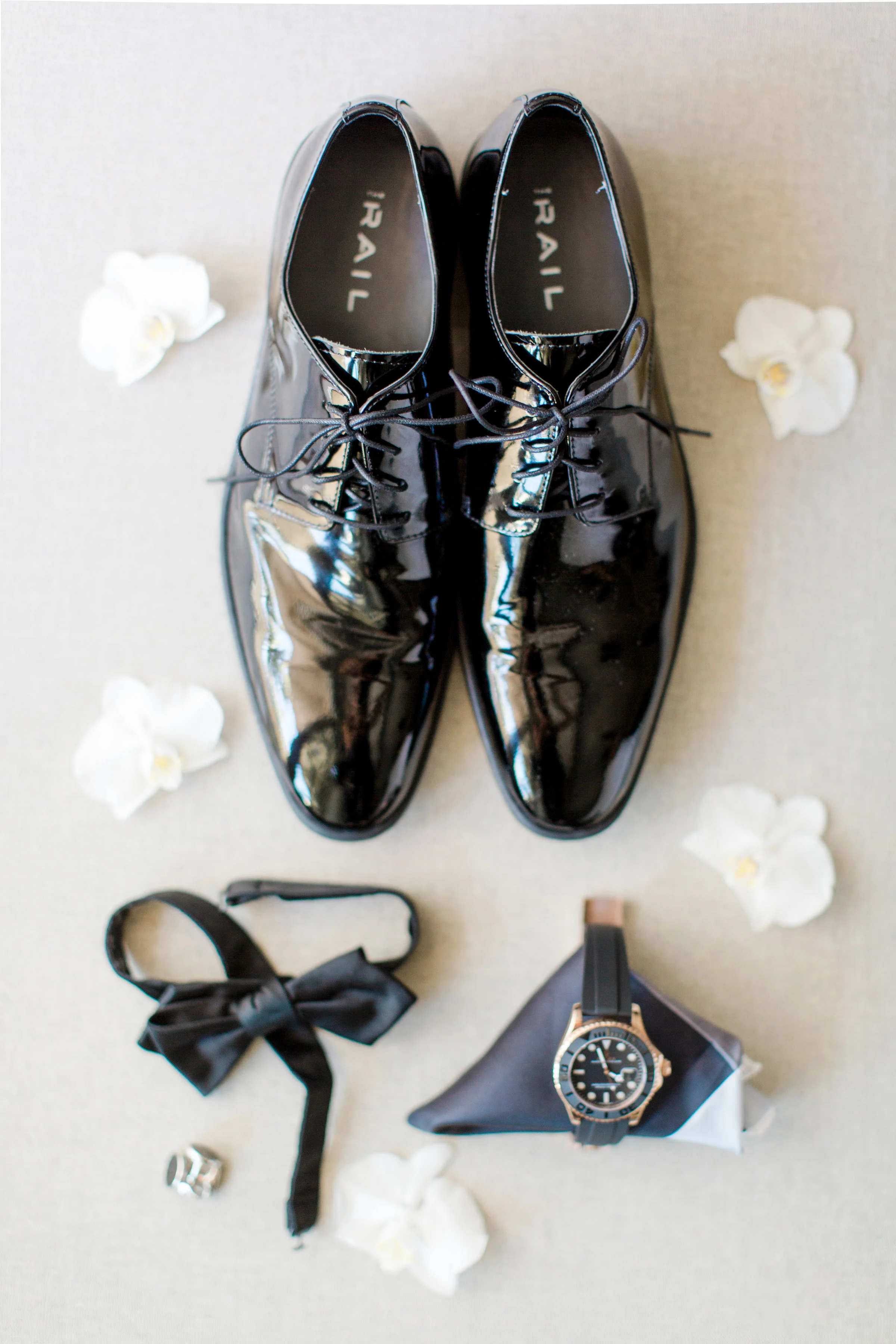 Groom's details including shoes and rolex and black tie