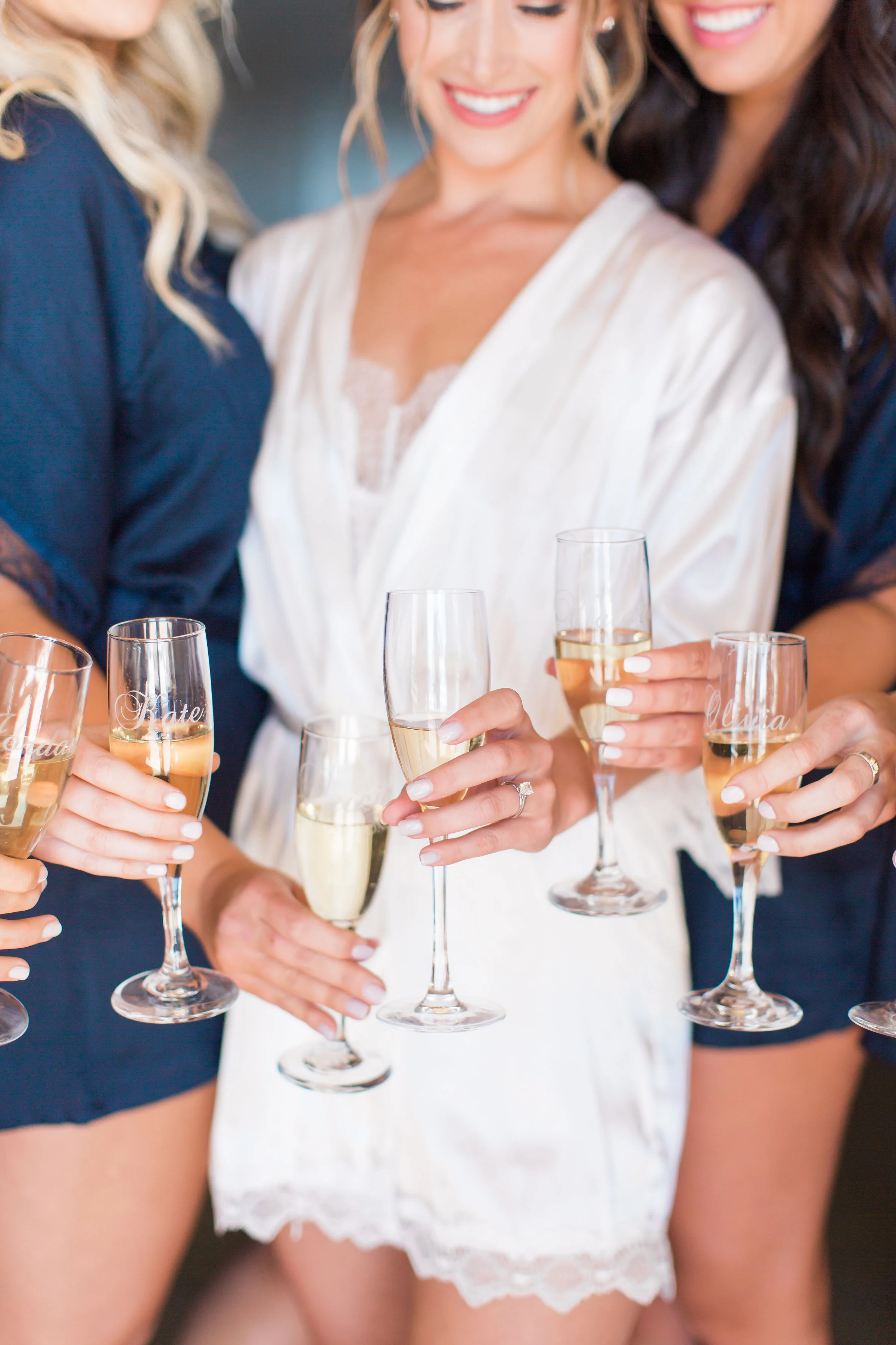 Bride and bridesmaids drinking champagne