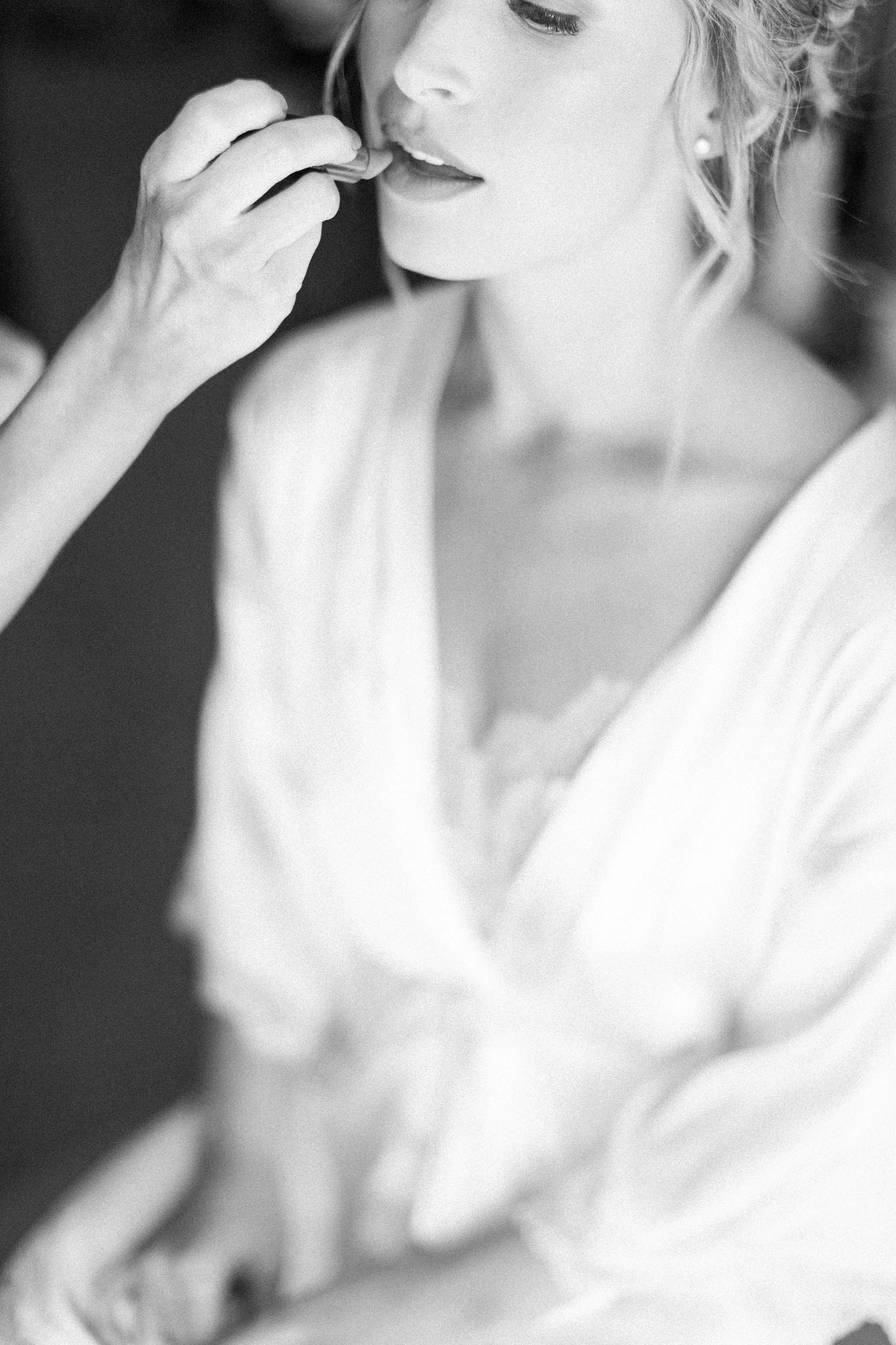 Bride having lipstick put on