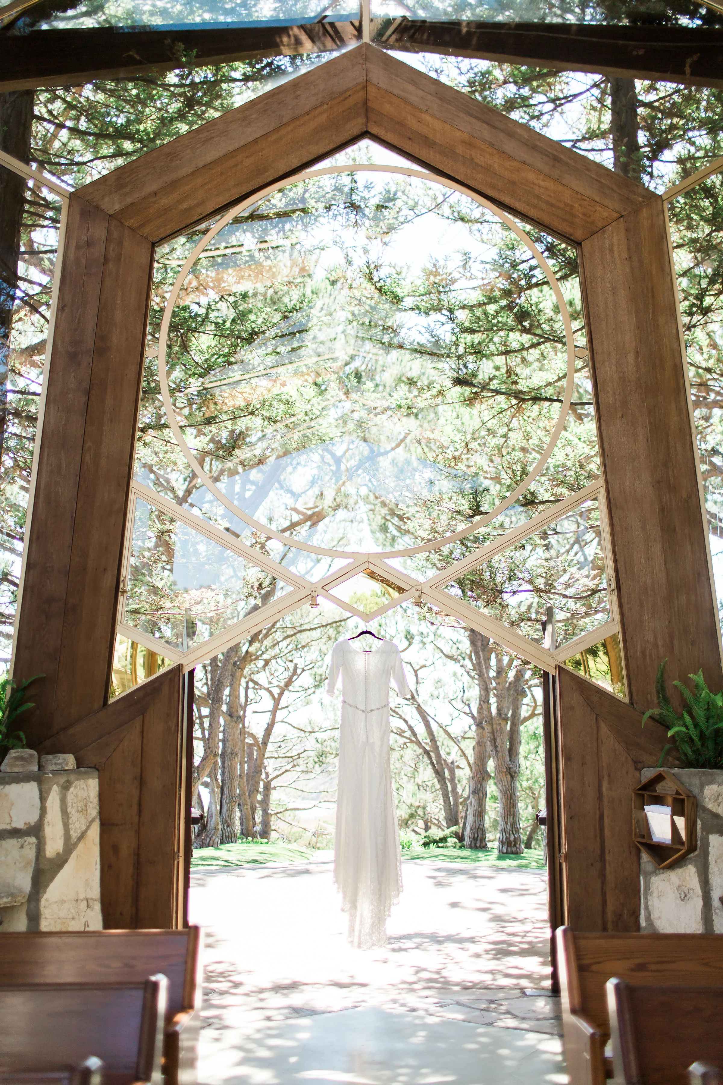 Bride's dress hangs from the entrance of Wayfarers chapel