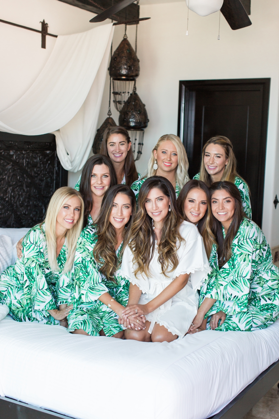 bride on bed with bridesmaids