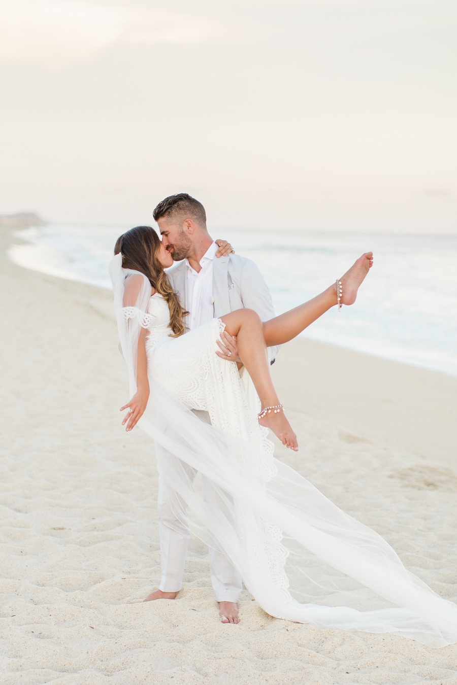 Groom picks up bride pose