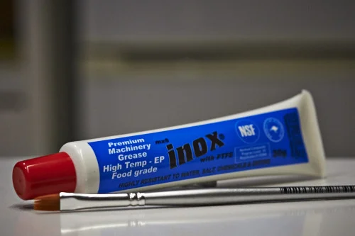 Standard white grease and paintbrush