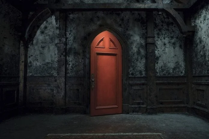 One can only assume this bright door in the decaying mansion is opening itself in Netflix's The Haunting of Hill House .
