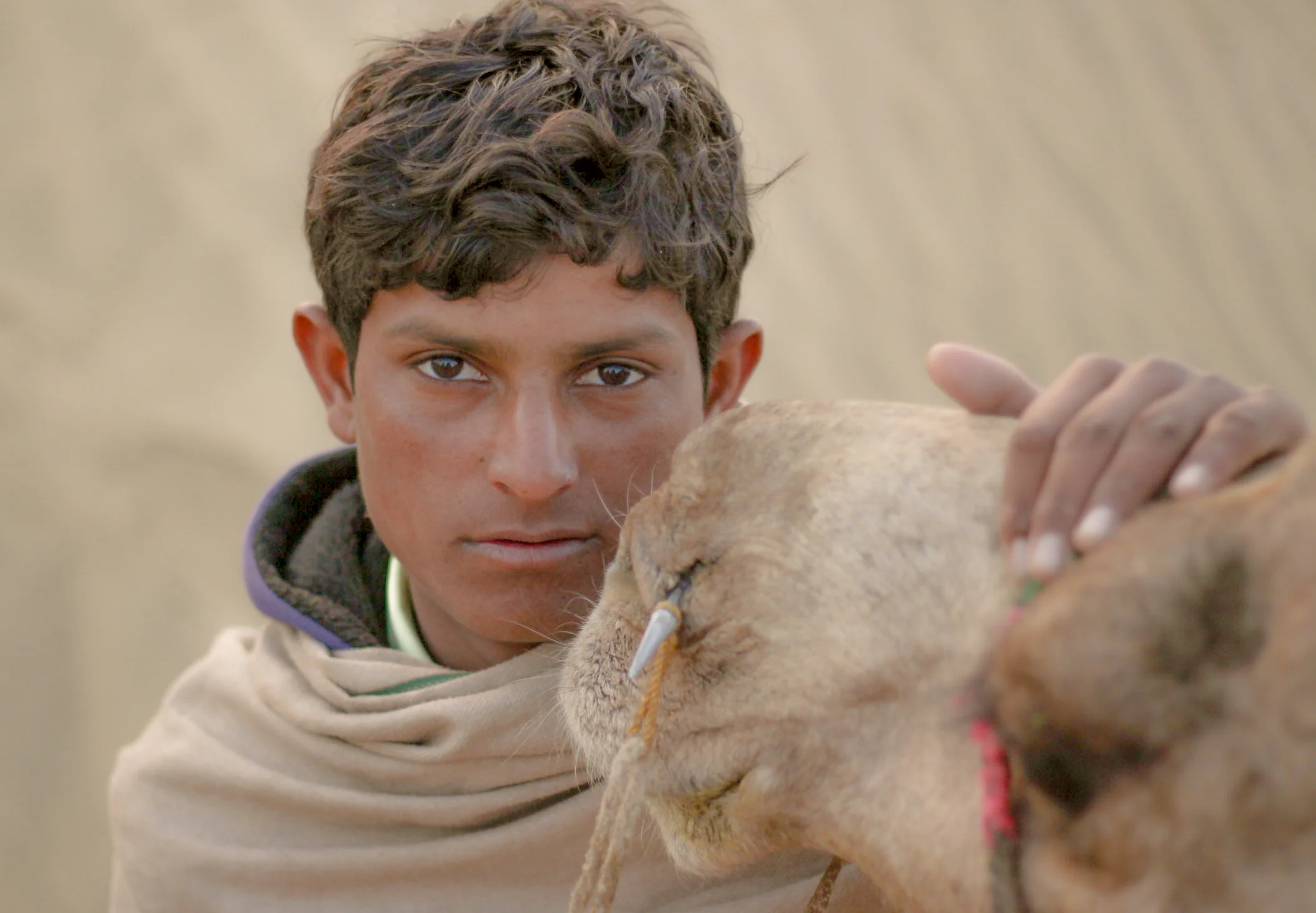  Sahir Khan, aged 18, takes his camel named Hrithik Roshan out on the sand-dunes in Rajasthan. He makes money by &nbsp;taking tourists for camel rides and prefers his job to attending school. 