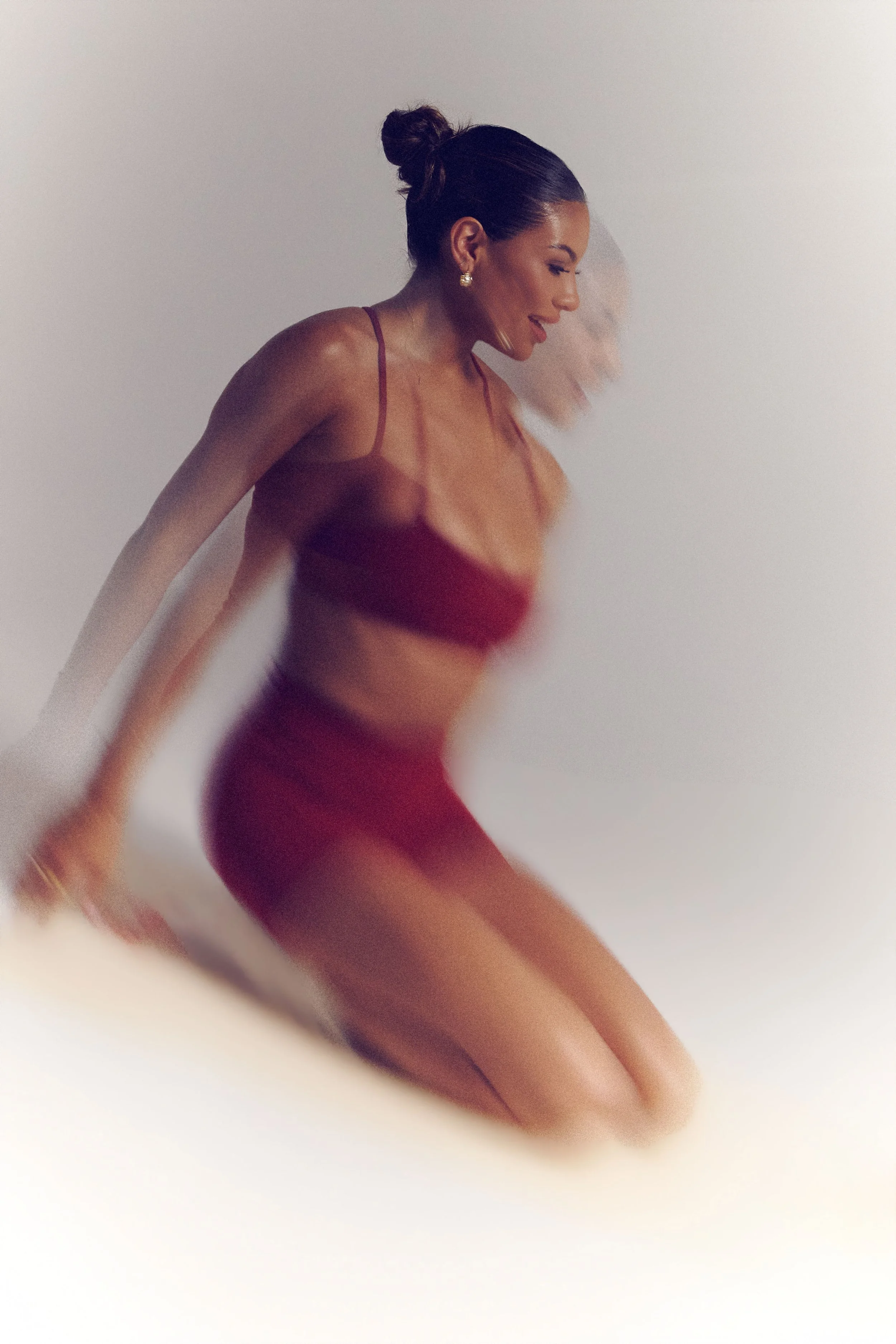 james-davis-commercial-photography-decidere-sport-burgundy-set-motion-blur-seated.jpg