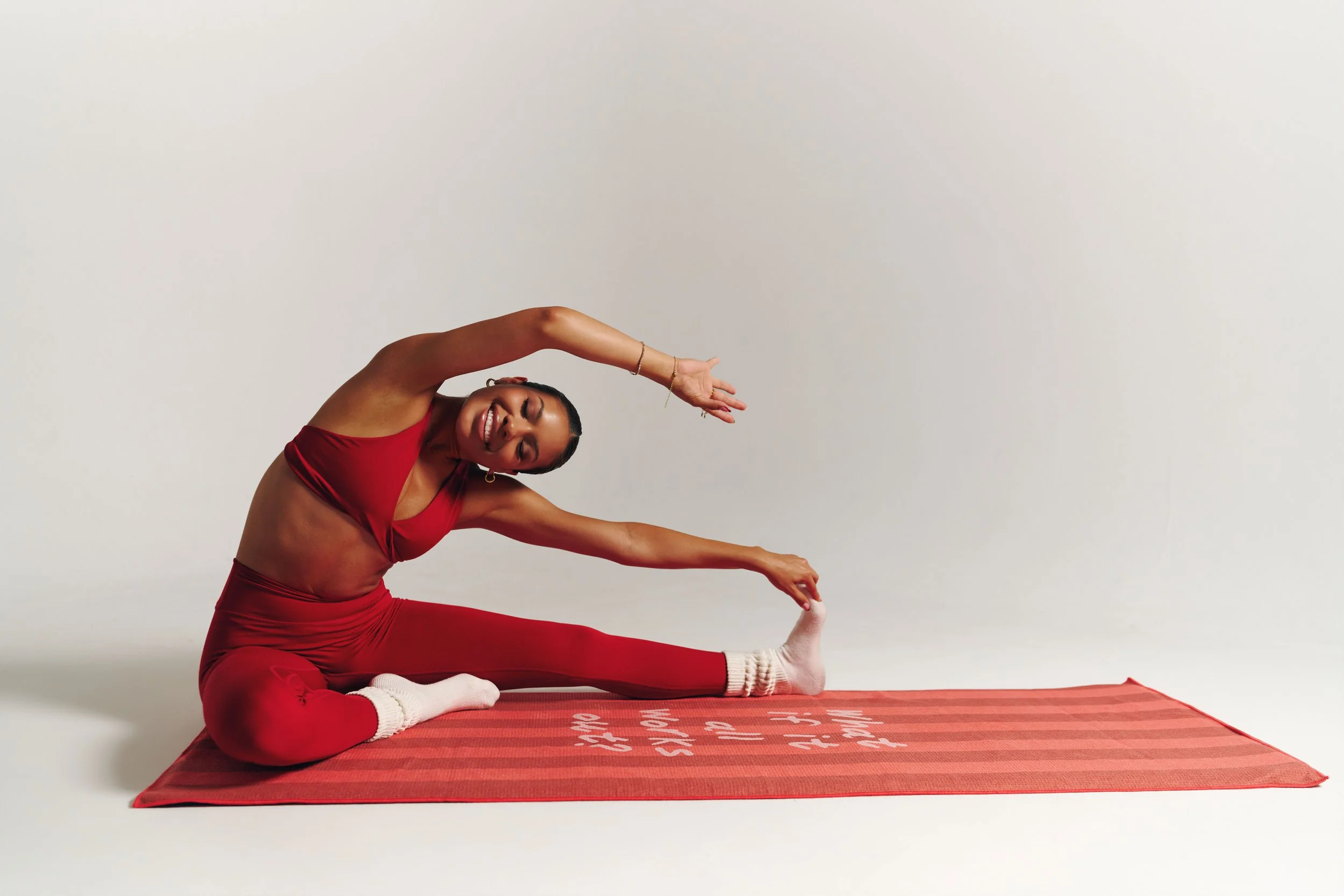 james-davis-commercial-photography-decidere-sport-red-activewear-seated-side-stretch-reach.jpg