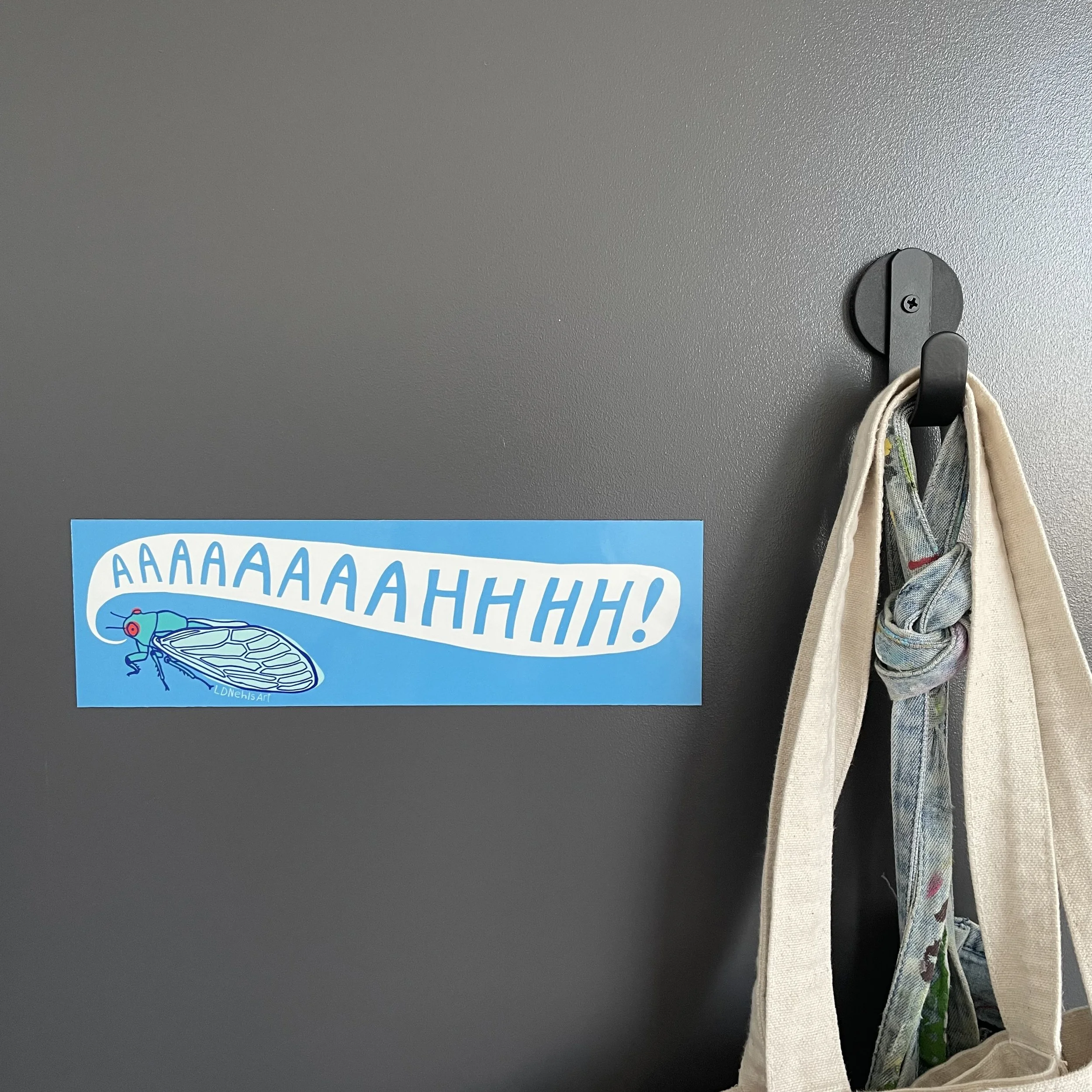 screaming cicada bumper sticker on door.jpg