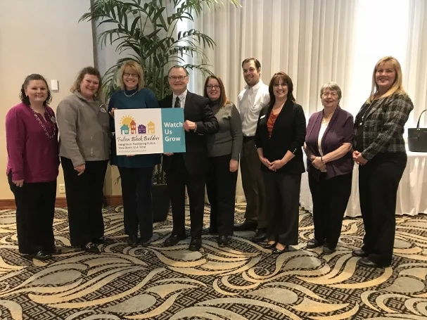 From the left, Jennifer Whalen, Reyne Pierce, Fulton Block Builders (FBB) volunteers, Karen Perwitz, of Operation Oswego County Inc. (OOC) and FBB, Michael Treadwell, Executive Director OOC Inc., Evelyn LiVoti, Austin Wheelock of OOC and FBB committee members Cheryl Baldwin, Carol Streeter and Penny Halstead.