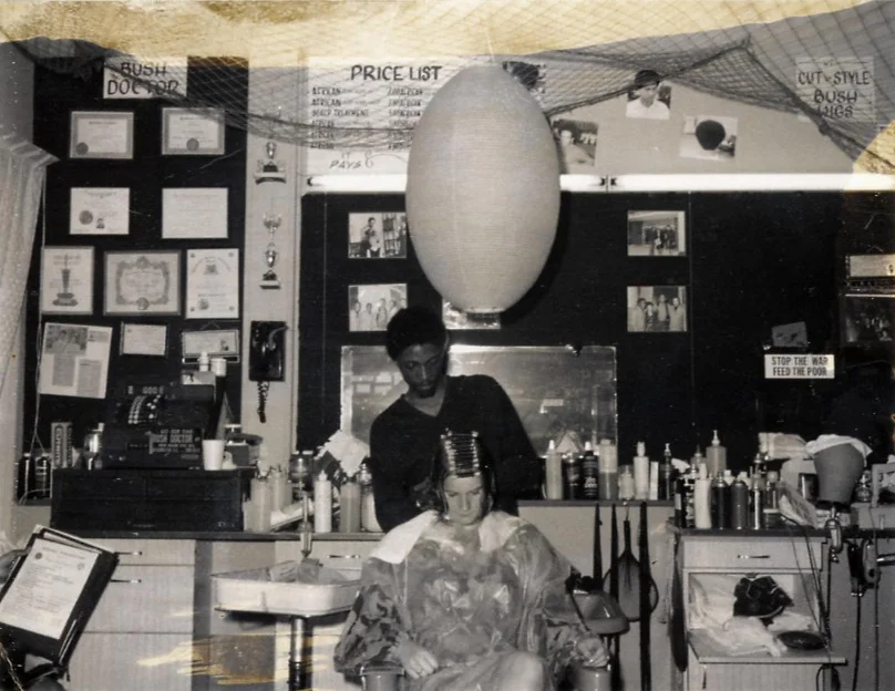 Nate the Bush Doctor at work in his Deane Avenue shop. c1969-1970. Notice the “Stop the War, Feed the Poor” sign. NMAH, SI.