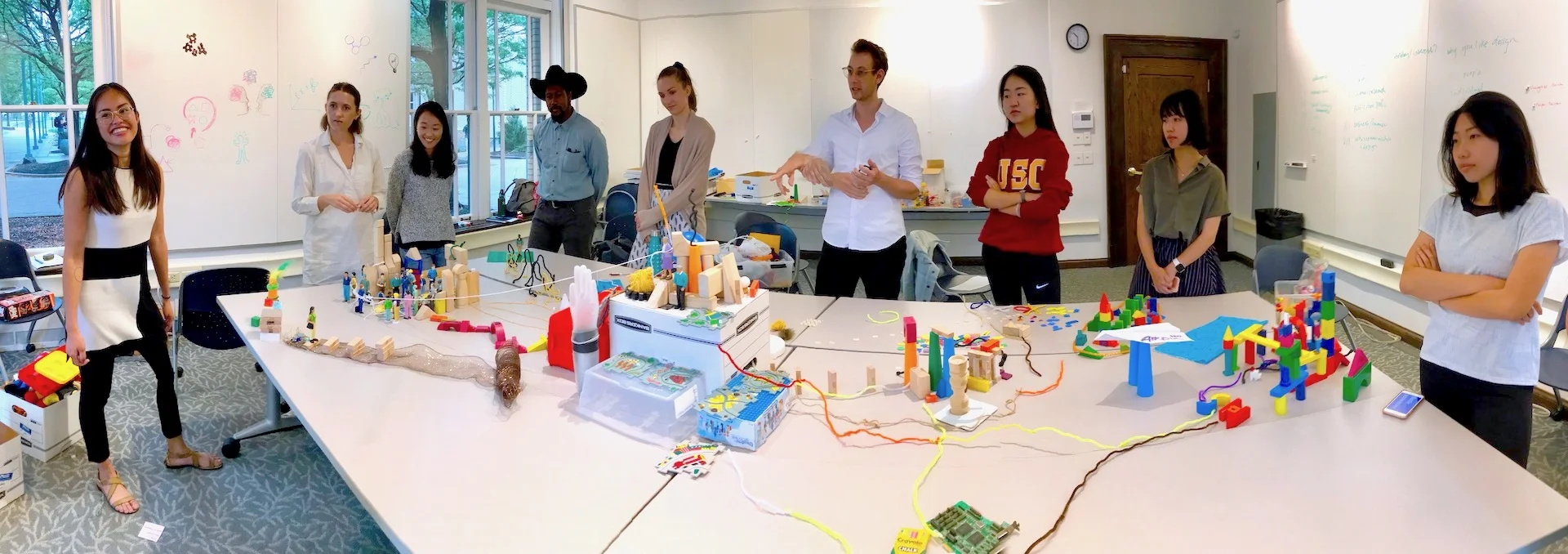 The center represents CMU, and each student worked to recreate elements of their journey to this graduate program. Whiteboards contain written facts about the cohort and their connections to the field of design (right), and our pictographic expression of the core principles of design (left).