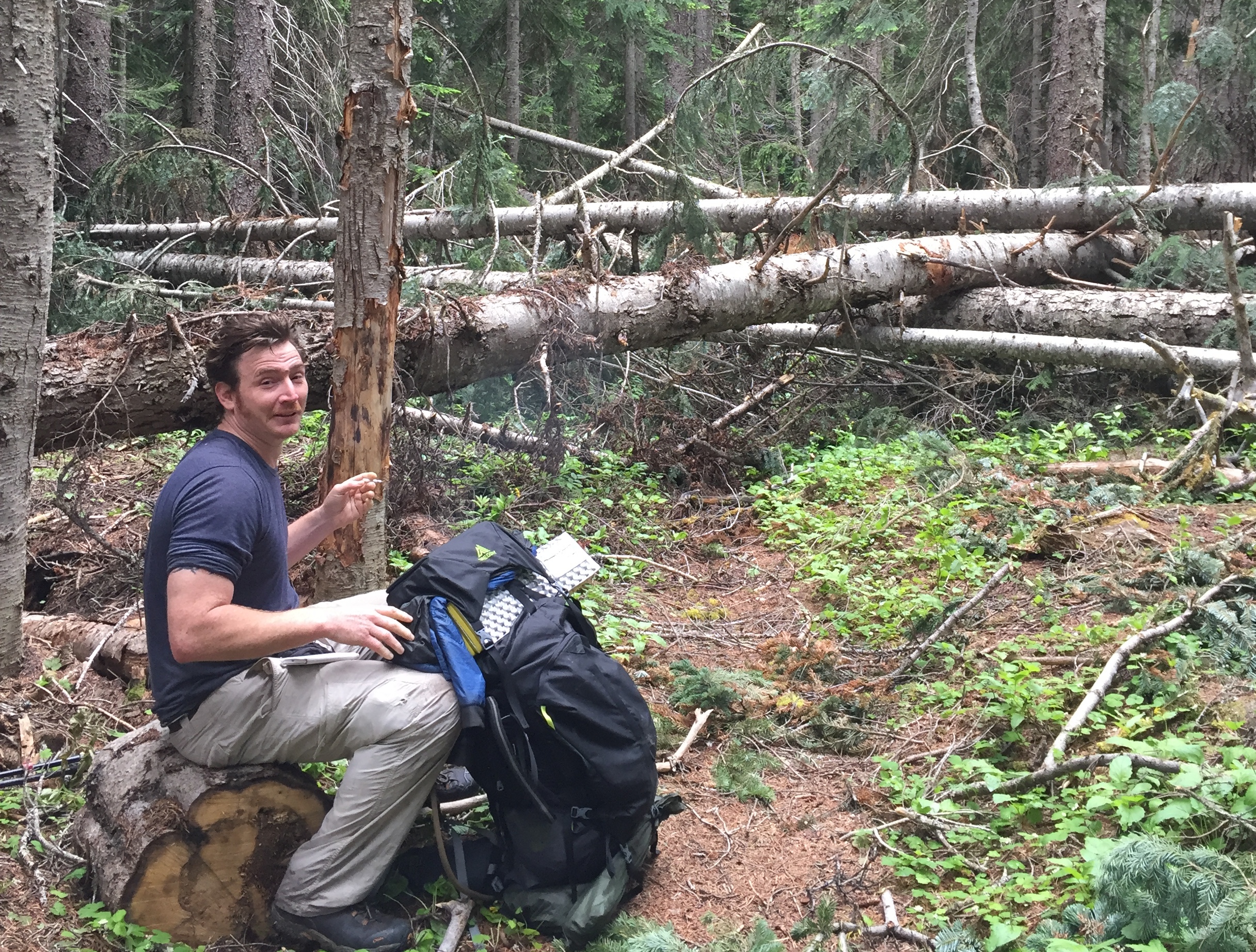 Karma Forward taking a break before a mile section of blow downs near the Methow River, north of Rainy Pass