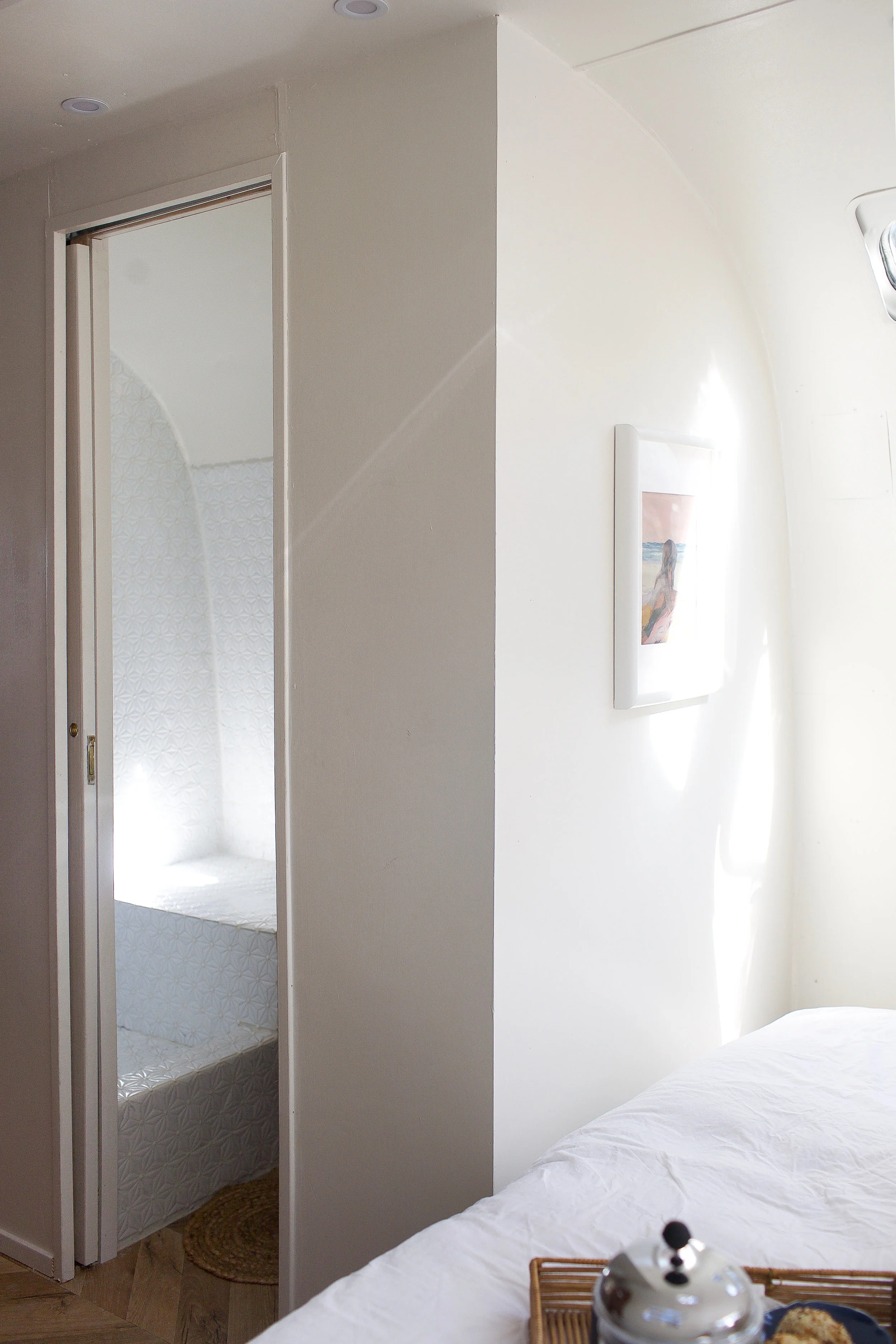 Sneaking a peek into the bathroom, which closes off with a slimline pocket door, from the spacious bedroom. The shower tile is from Lowe’s.