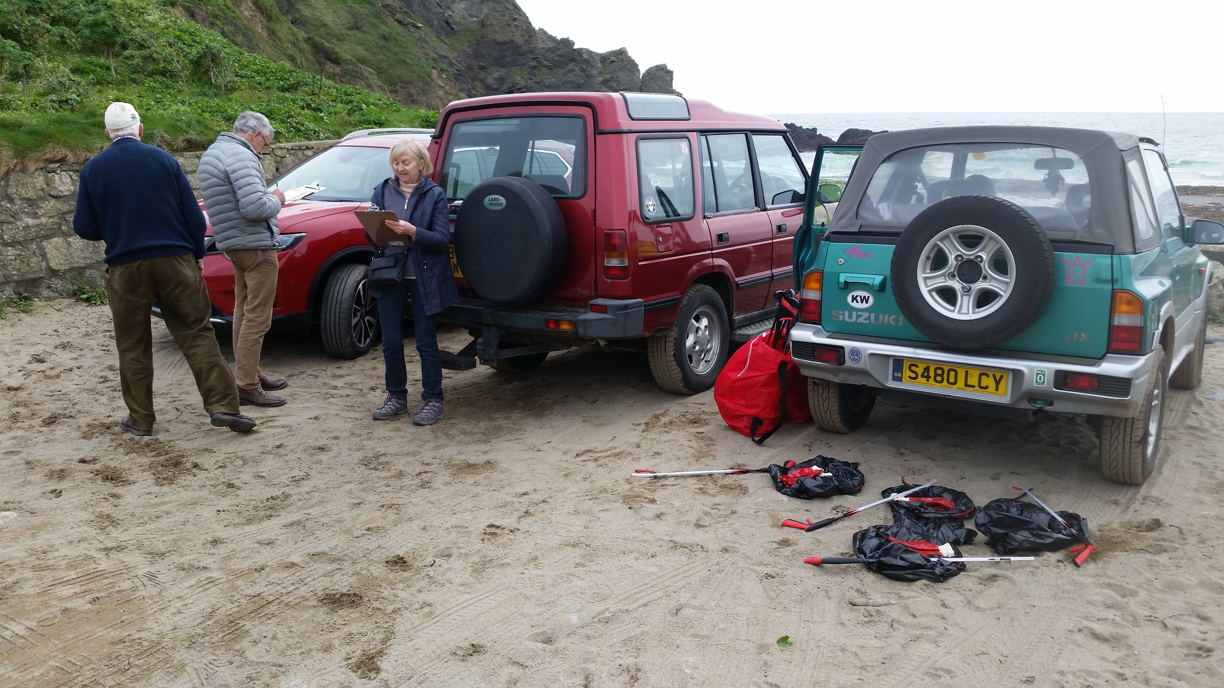 Robert, Robert and Carolyn filling out Dr. Kayleigh Wyles's well being questionnaires whilst we prepare for a beach clean.