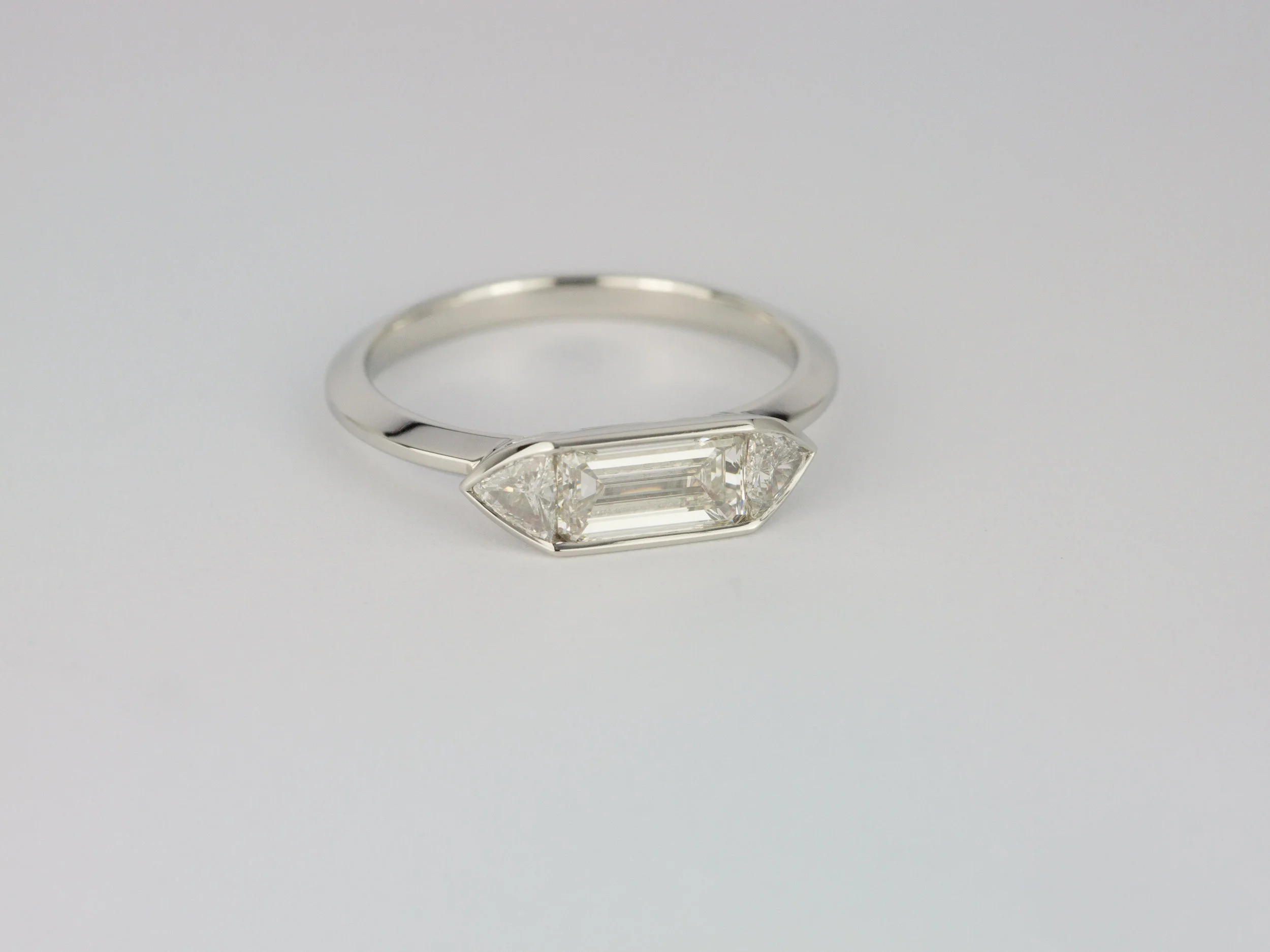 Emerald cut and trilliant cut diamond engagement ring