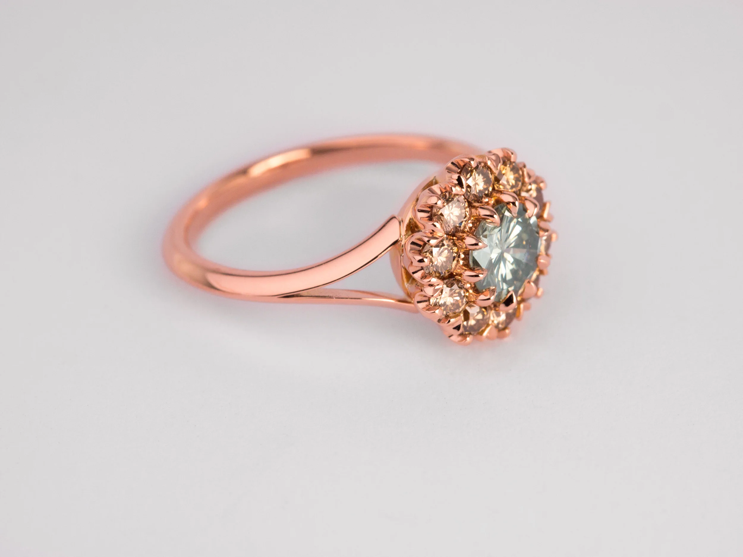 Champagne diamond cluster engagement ring in rose gold.
