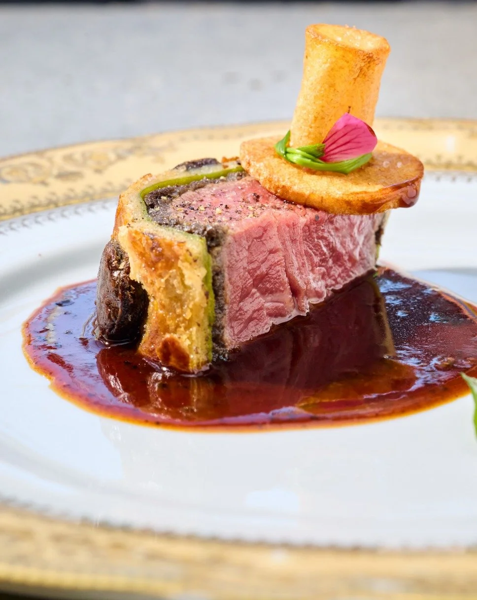 Hats off for our Beef Wellington - or, hats on? This is a hat, in a hat, in a hat...where the first hat is made of crispy potato and the last is actually a vase. It makes sense in person, promise. Under all that is filet mignon wrapped in mushrooms d
