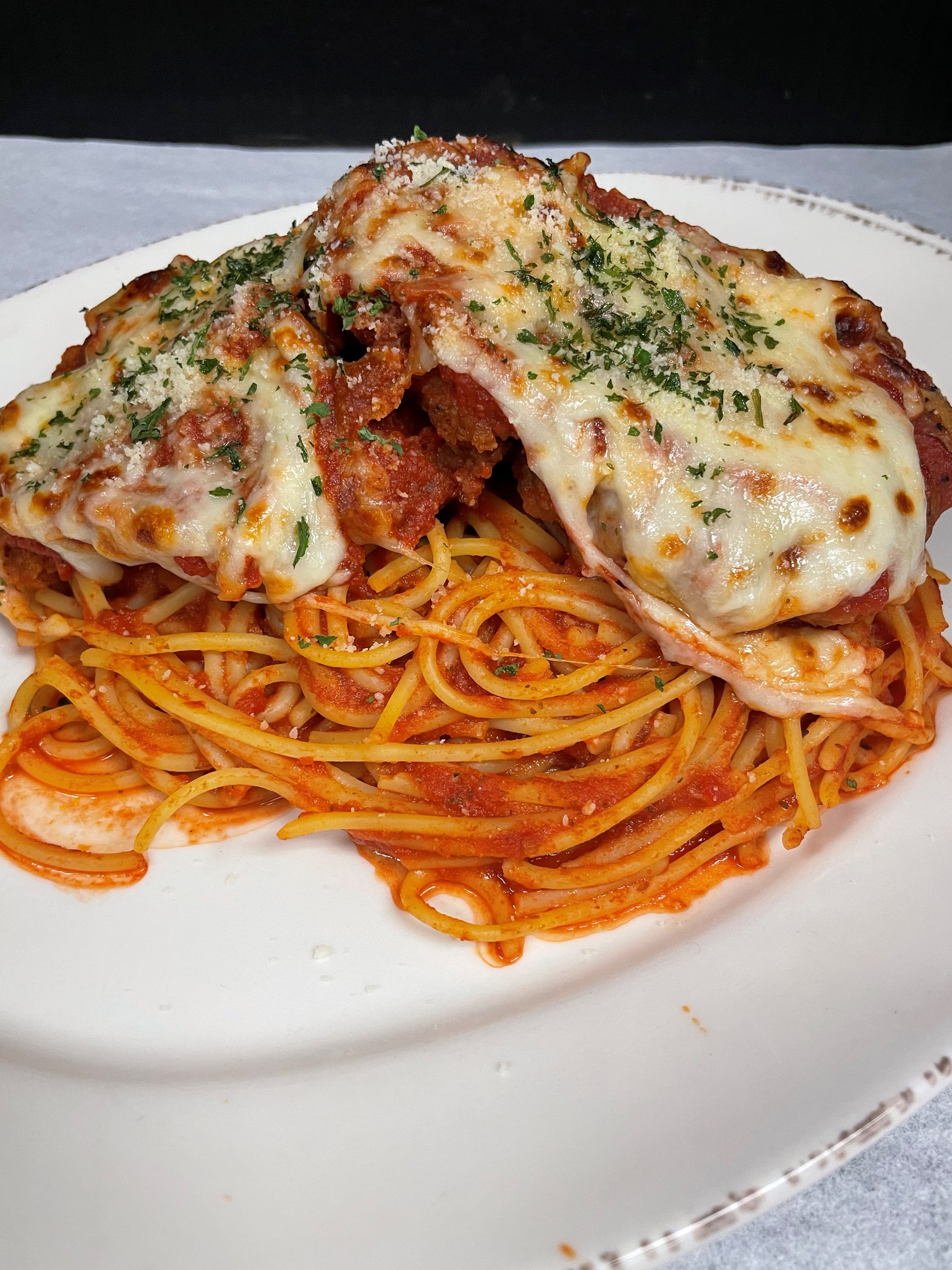 chicken in marinara, mozzarella & parmesan cheeses over spaghetti.jpg