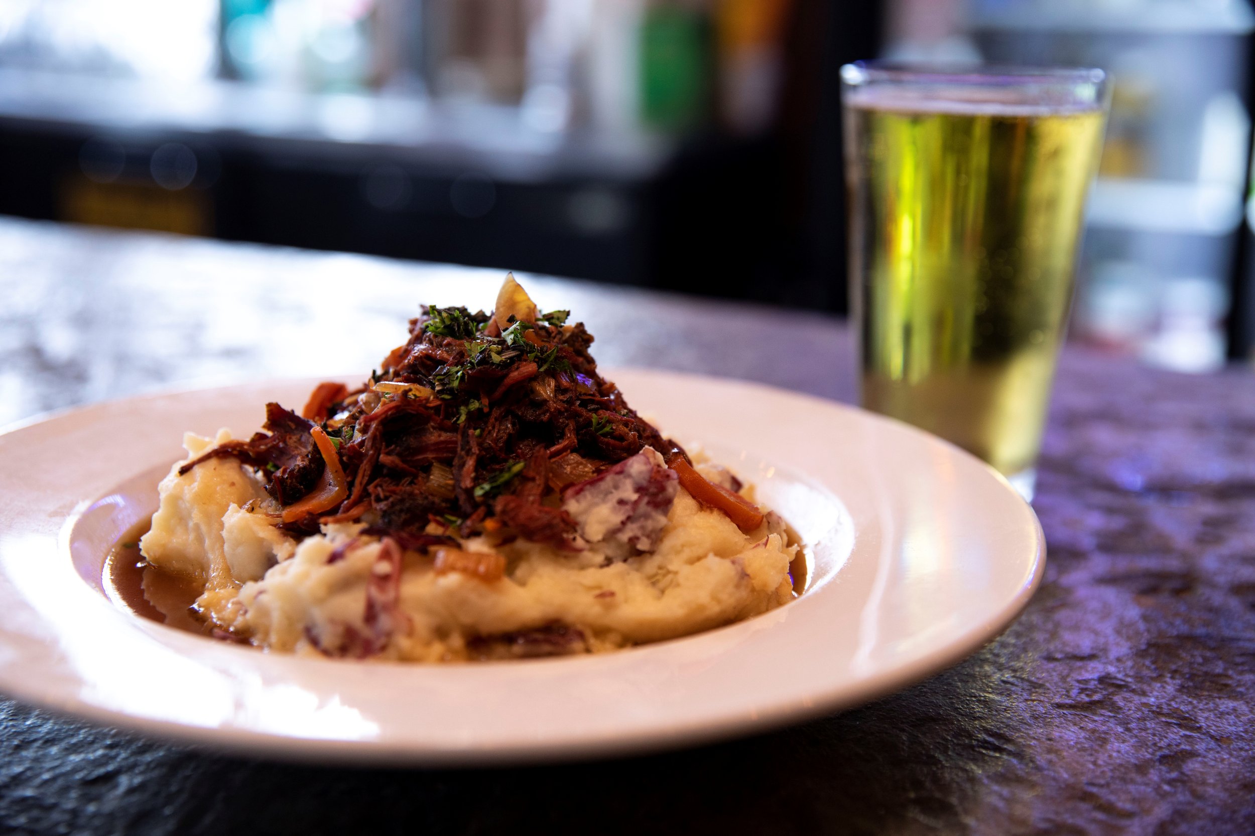 open faced roast beef over mashed potatoes smotherd in gravy with pint of beer.jpg