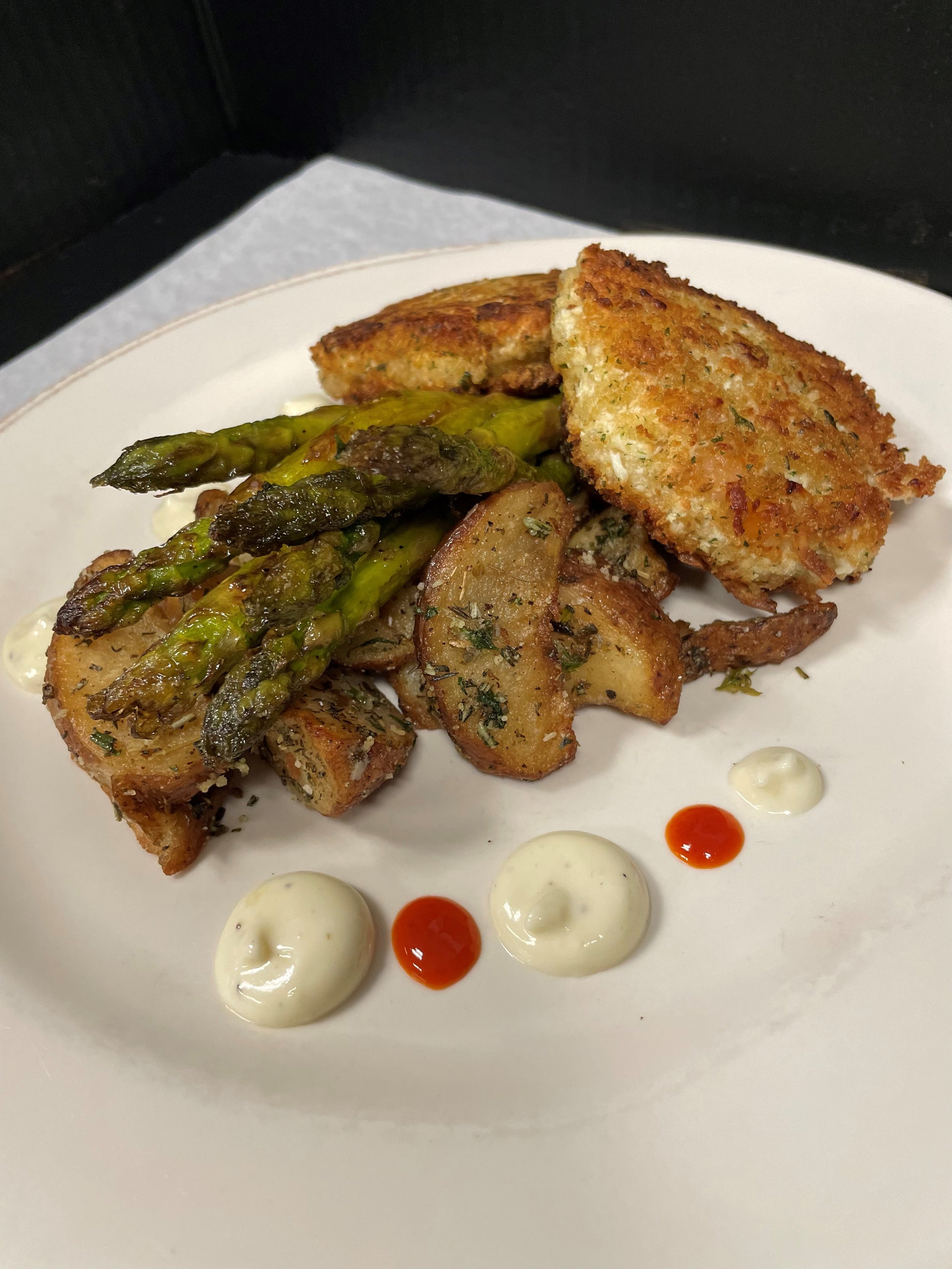 twin crab cakes, parmesan herb roasted potatoes, grilled asparagus with a citrus hollandaise, honey sriracha.jpg