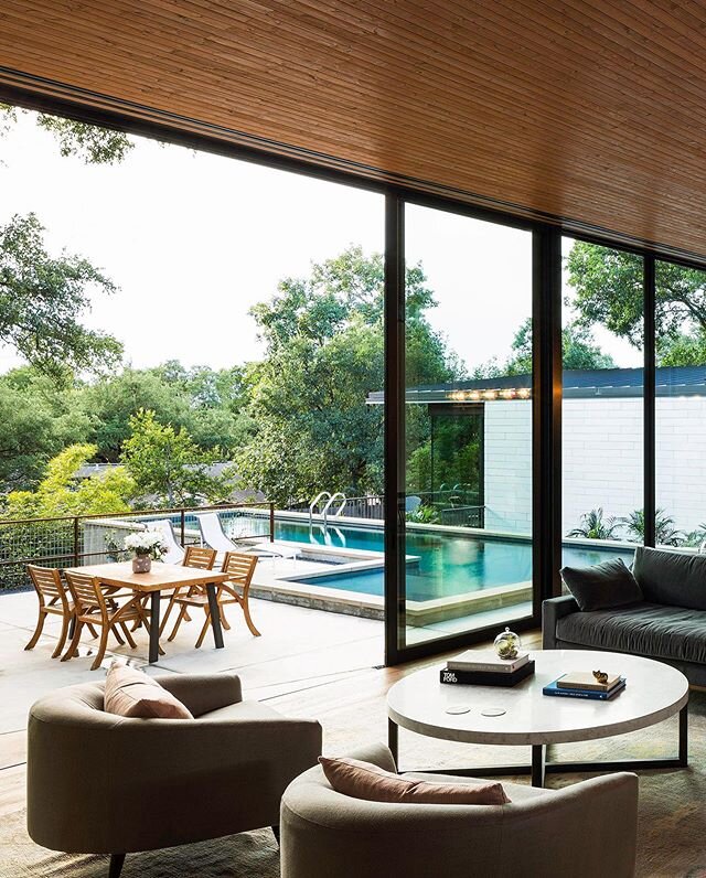 We designed the private spaces in this house to be behind white limestone walls, but the living area is meant to be as open as possible. The lap pool also became a nice backdrop for these living and dining spaces. 📷 @jakeholt⁠⠀
.⁠⠀
#1700atx⠀
.⠀
#aus