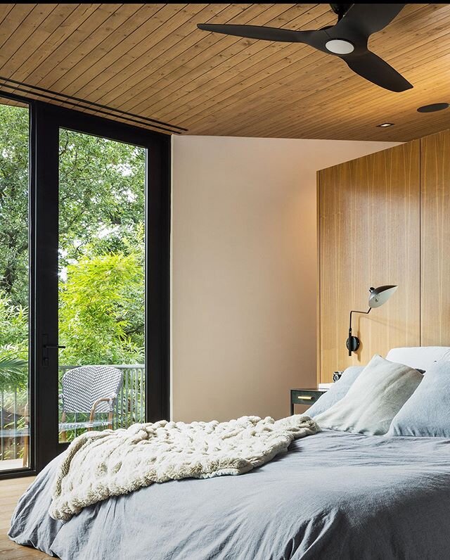 We designed this master suite to have a built-in vanity element separating the sleeping area from the closet space. The ceiling connects the two spaces and we think it gives a larger feel to the bedroom while still giving visual privacy from the clos
