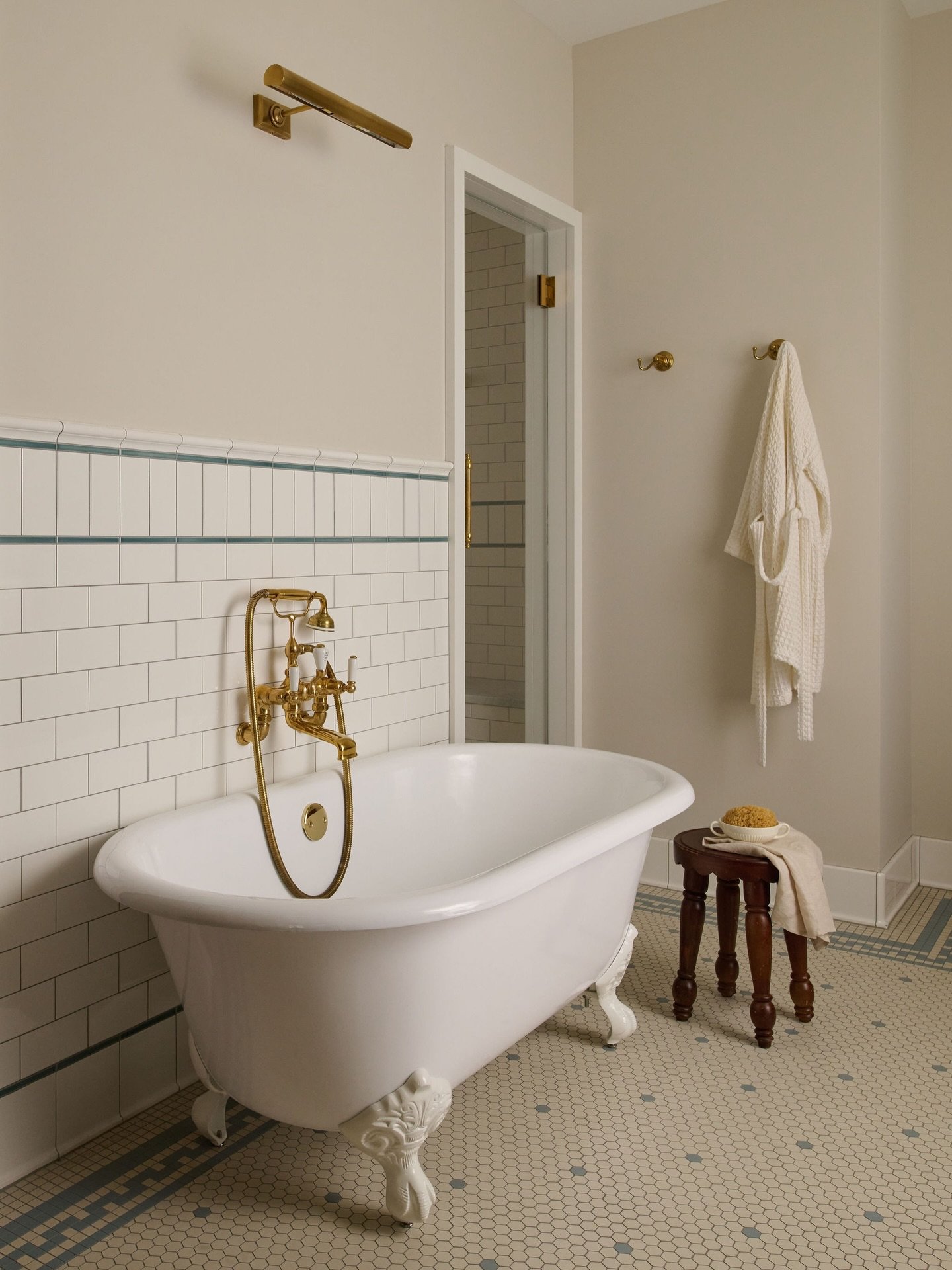 A quiet, timeless primary bathroom centered around a classic freestanding cast iron clawfoot tub. ⁠
⁠
Finished with historic subway tile bringing a touch of vintage charm, mosaic flooring adding texture and character, and unlacquered brass that will 